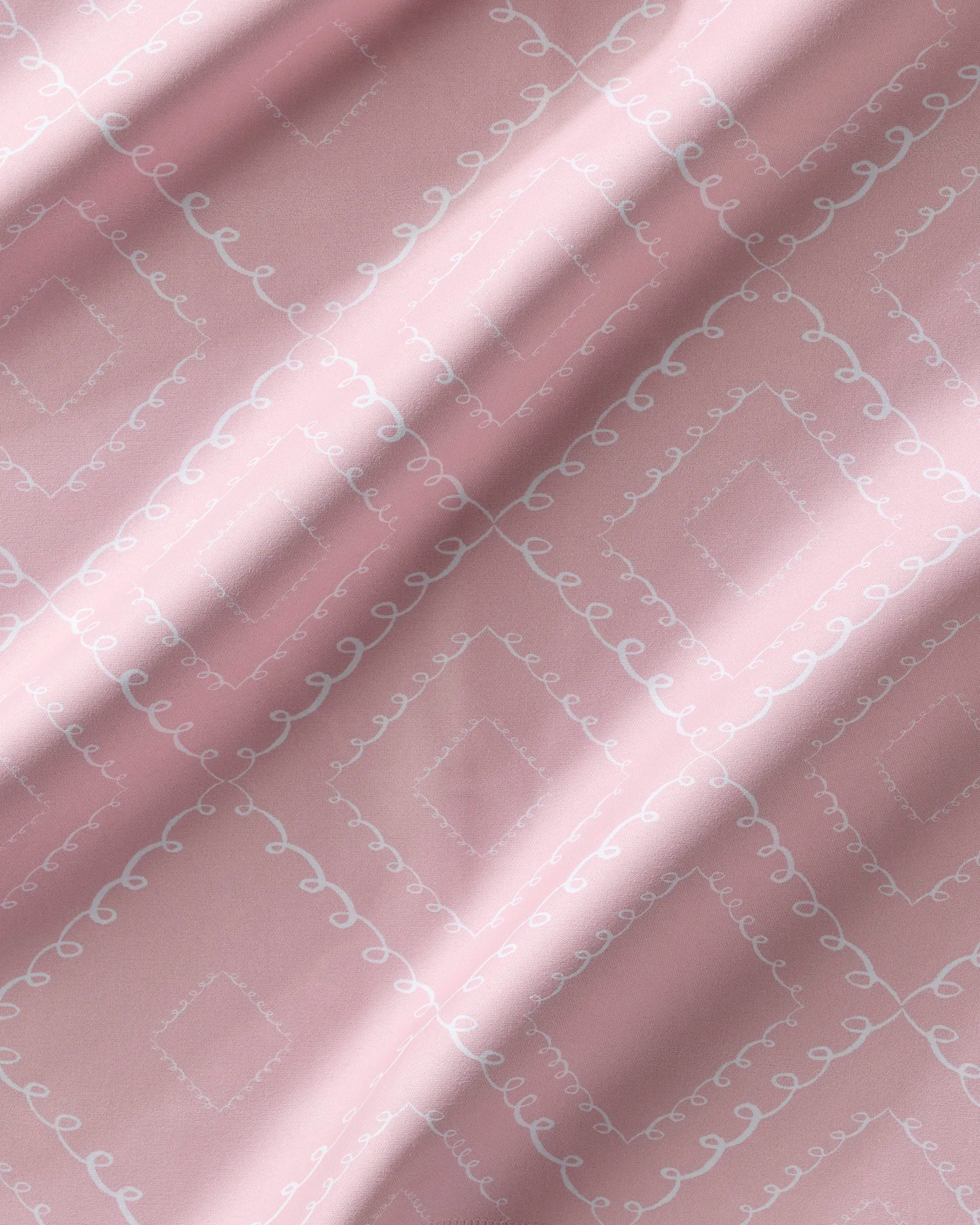 Elena Fay’s Twirls napkins feature soft pink eco-friendly fabric with a diamond pattern and delicate white curves. Gentle folds add shadows and highlights, making this Dinner Napkin Set perfect for stylish dining.