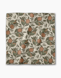 The Geometry Valencia dinner napkin features a square, absorbent cloth with vintage-style oranges and green leaves on a cream background—perfect for any table setting.