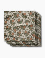 Geometry’s Valencia placemats feature a botanical orange and green leaf print on a cream background, arranged in an overlapping stack—perfect for pairing with absorbent cloth napkins for a coordinated dining table.