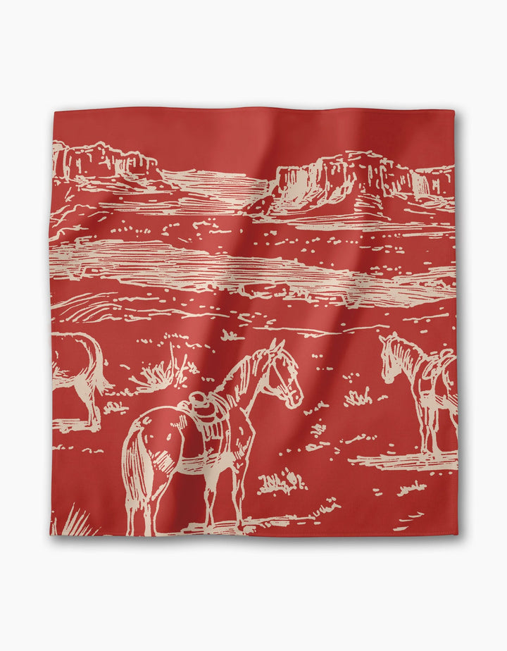 The Geometry Western Scene bandana features a red background with a cream line drawing of three saddled horses in a desert landscape with mesas—great to pair with eco-friendly or recycled dinner napkins.