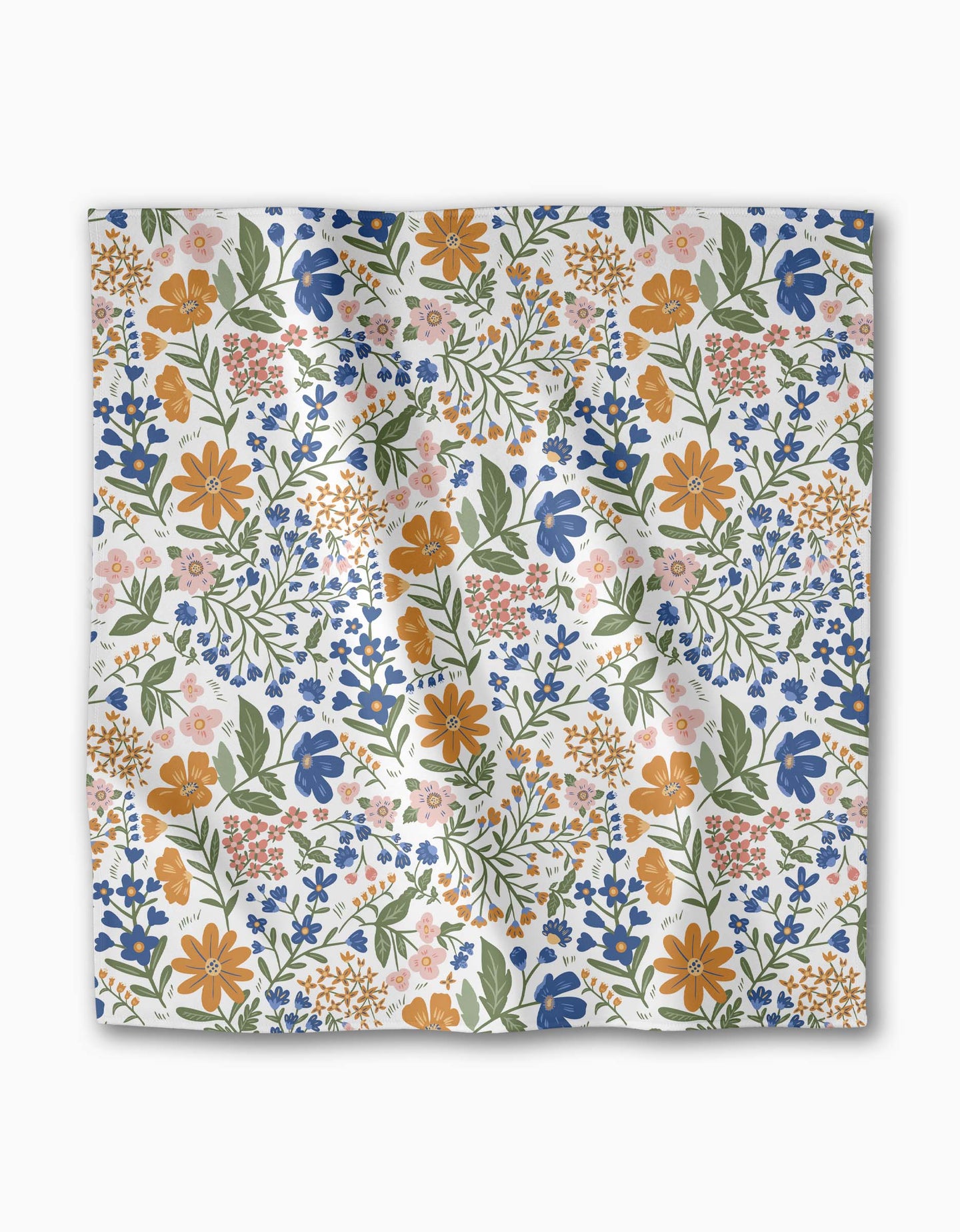 The Wildflower Vine Blush by Danelys Sidron is a square Geosuede fabric with a colorful floral pattern—orange, blue, pink, and yellow flowers with green leaves on white. The fabric appears slightly creased.