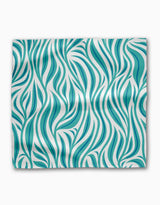 The Willow Wave by Rachel Parker is a rectangular Geosuede cloth featuring a teal and white abstract wavy pattern, resembling flowing leaves or strands, displayed flat on a white background with visible folds.