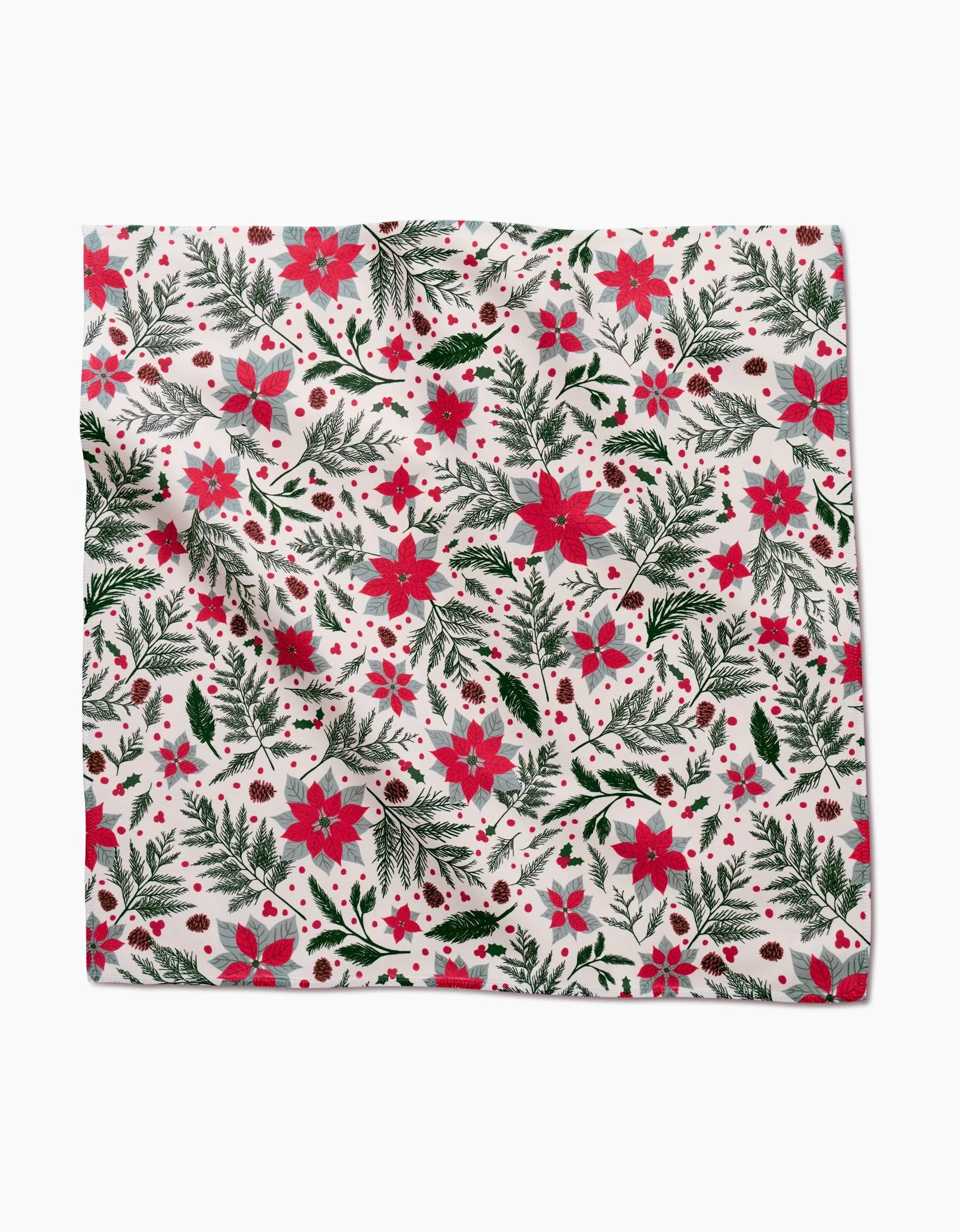 The Rebecca Bobko Woodland Poinsettia Geosuede napkin features a festive pattern with red poinsettias, green leaves, pinecones, and berries on white—perfect for your holiday dinner napkin set.