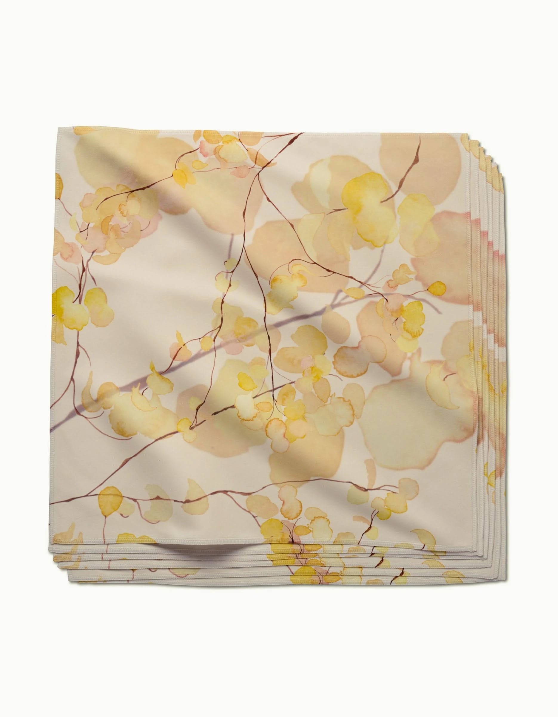 Yellow Fall dinner napkins by GEOMETRY, crafted from soft Geosuede Fabric, feature a watercolor botanical print with yellow and ivory leaves and thin brown branches on a light background.
