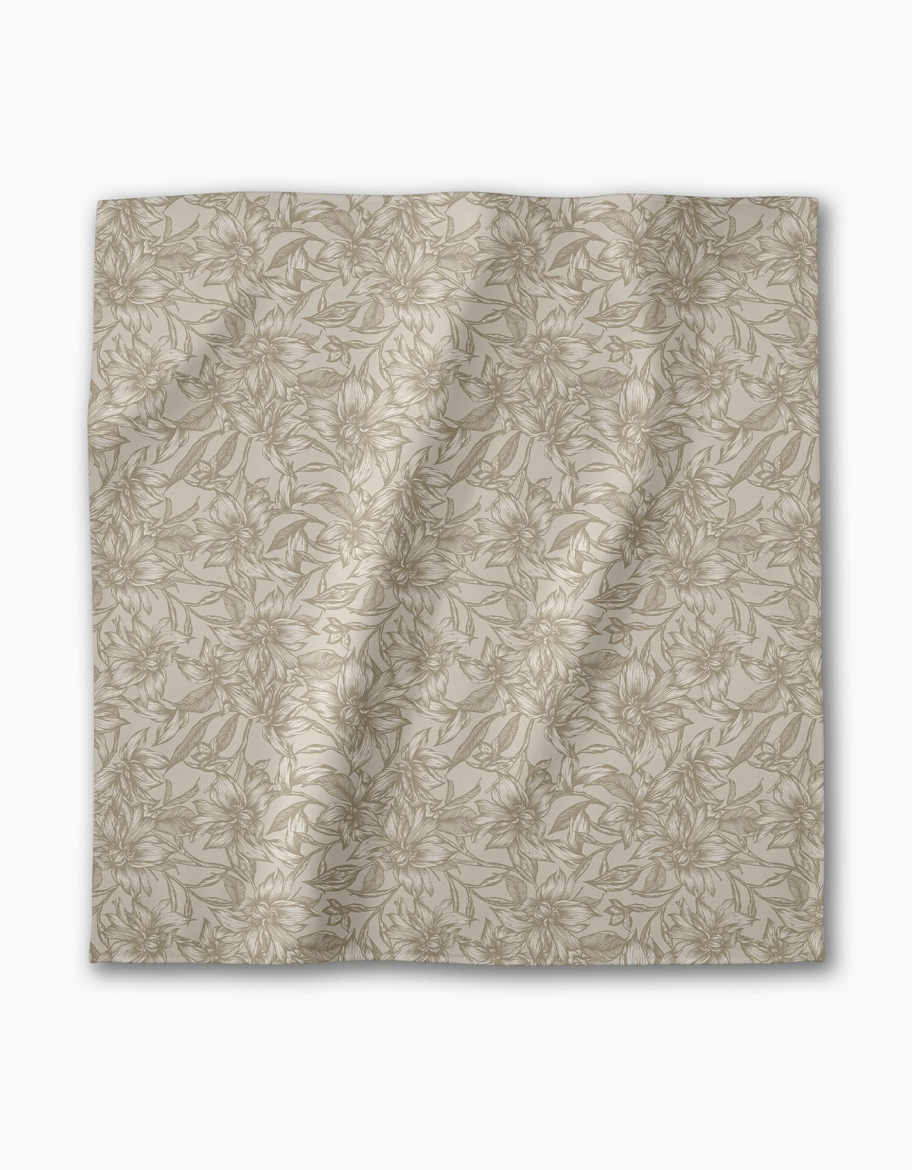 The Geometry Alba is a beige, square reusable napkin with a subtle, intricate floral pattern in light brown lines featuring leaves and flowers, shown laid flat with slight wrinkles on a white background.