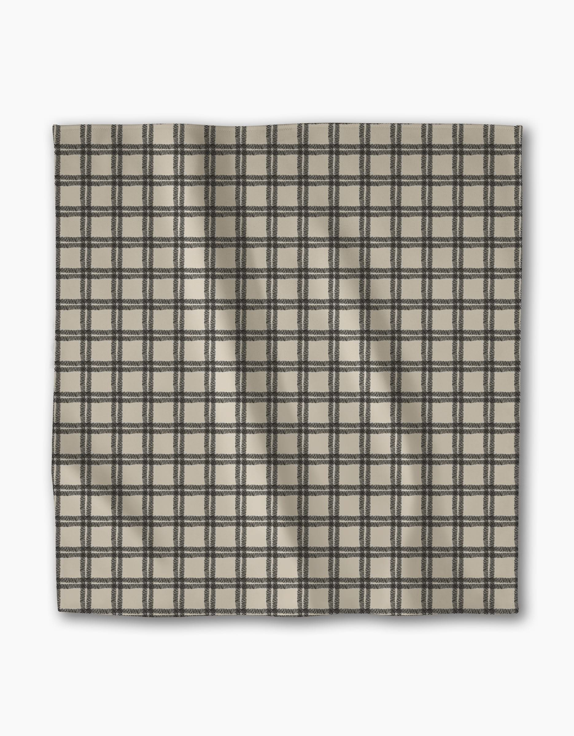 The Geometry Blackstone Dinner Napkin Set features rectangular beige fabric with a black checkered pattern, uniform grid lines, and subtle creases. Crafted from recycled materials for an eco-friendly, stylish table setting.