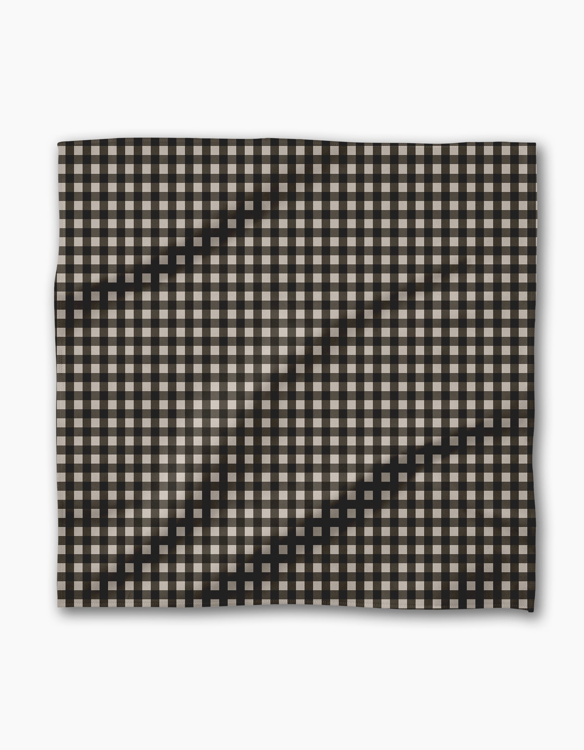 Geometry’s Charcoal Gingham features a black and white checkered fabric with visible waves and folds, set against a plain white background—perfect for your recycled Dinner Napkin Set.