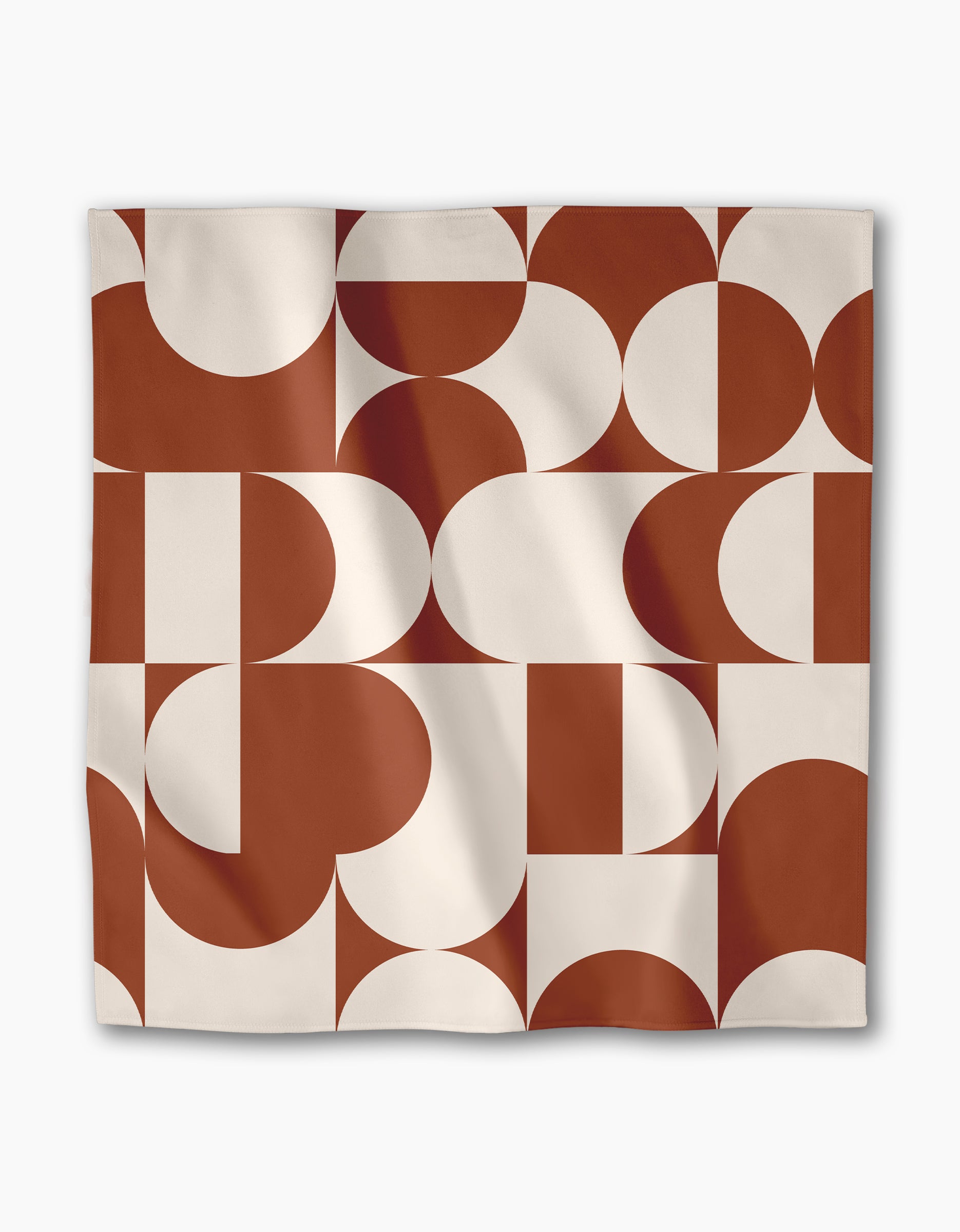 The Geometry Circle Playground is a reusable square cloth napkin with a bold, modern abstract design featuring rust-red and cream geometric shapes—circles, semi-circles, and rectangles—on a white background.