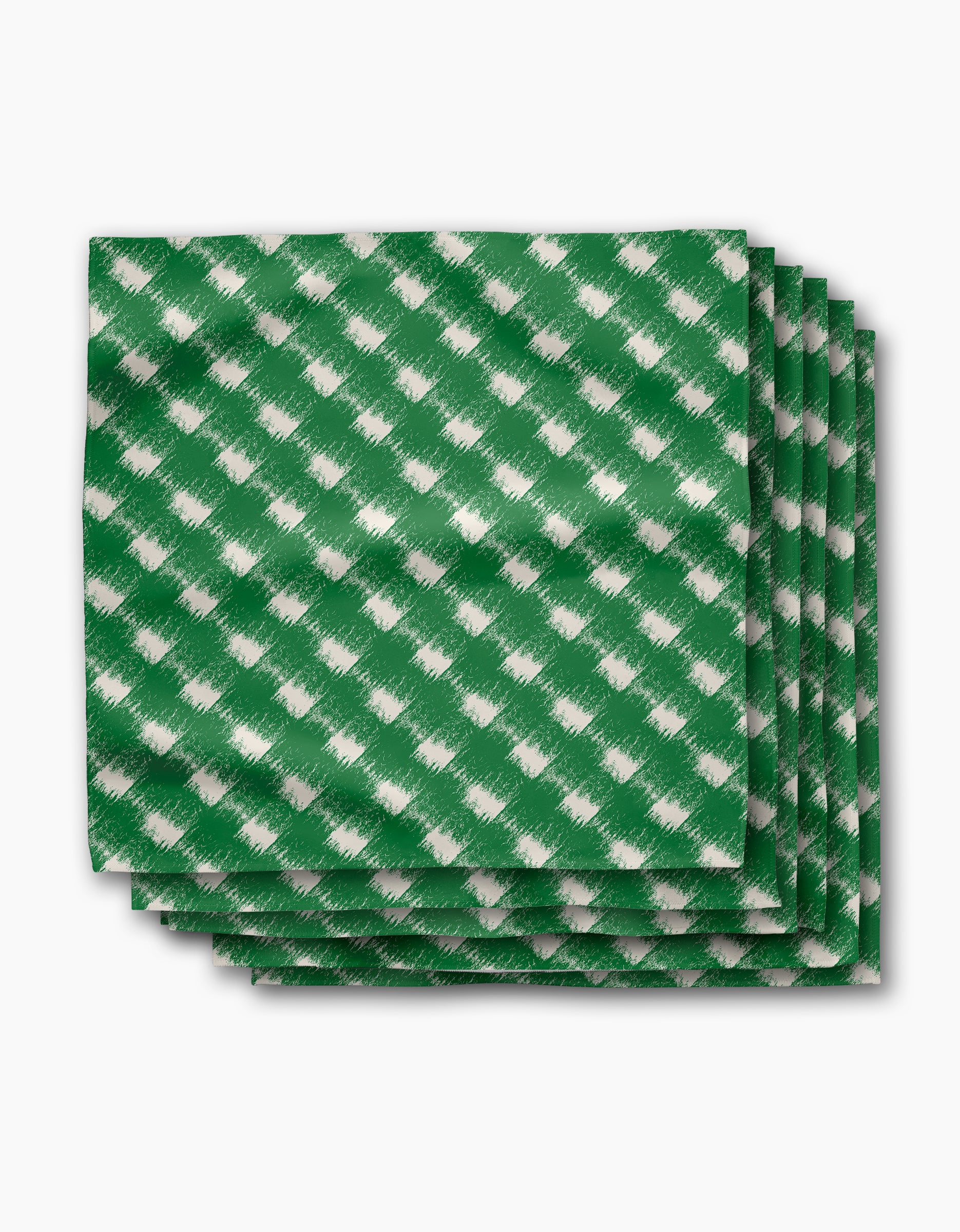 The Geometry Hairy Check Green Dinner Napkin Set features four green napkins with a white diagonal checkered pattern, made from recycled materials and neatly stacked on a white background.
