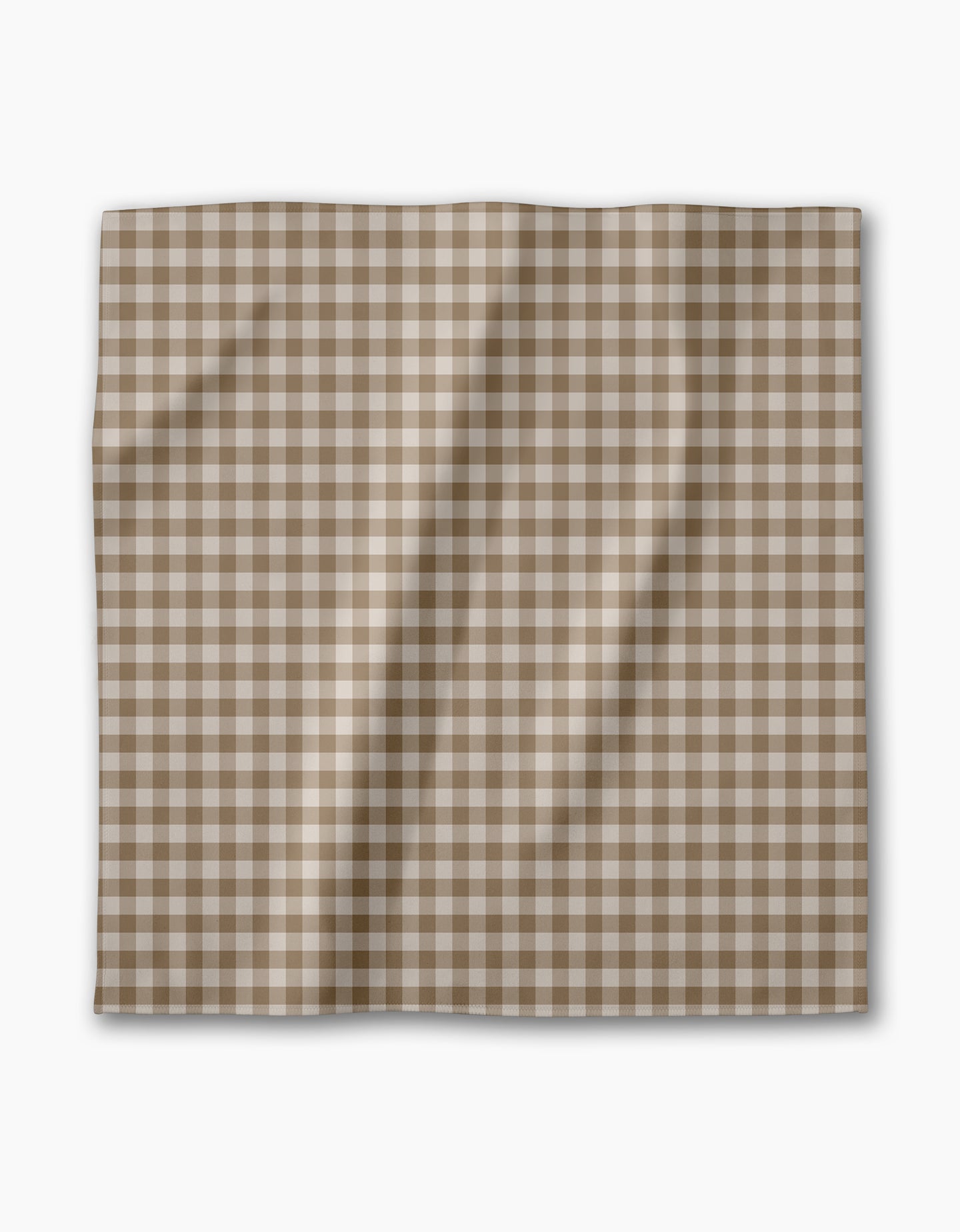 The Hazel Gingham reusable cloth napkin by Geometry features a brown and white checkered pattern, shown laid flat with gentle folds on a plain white background—ideal for an eco-friendly dinner napkin set.
