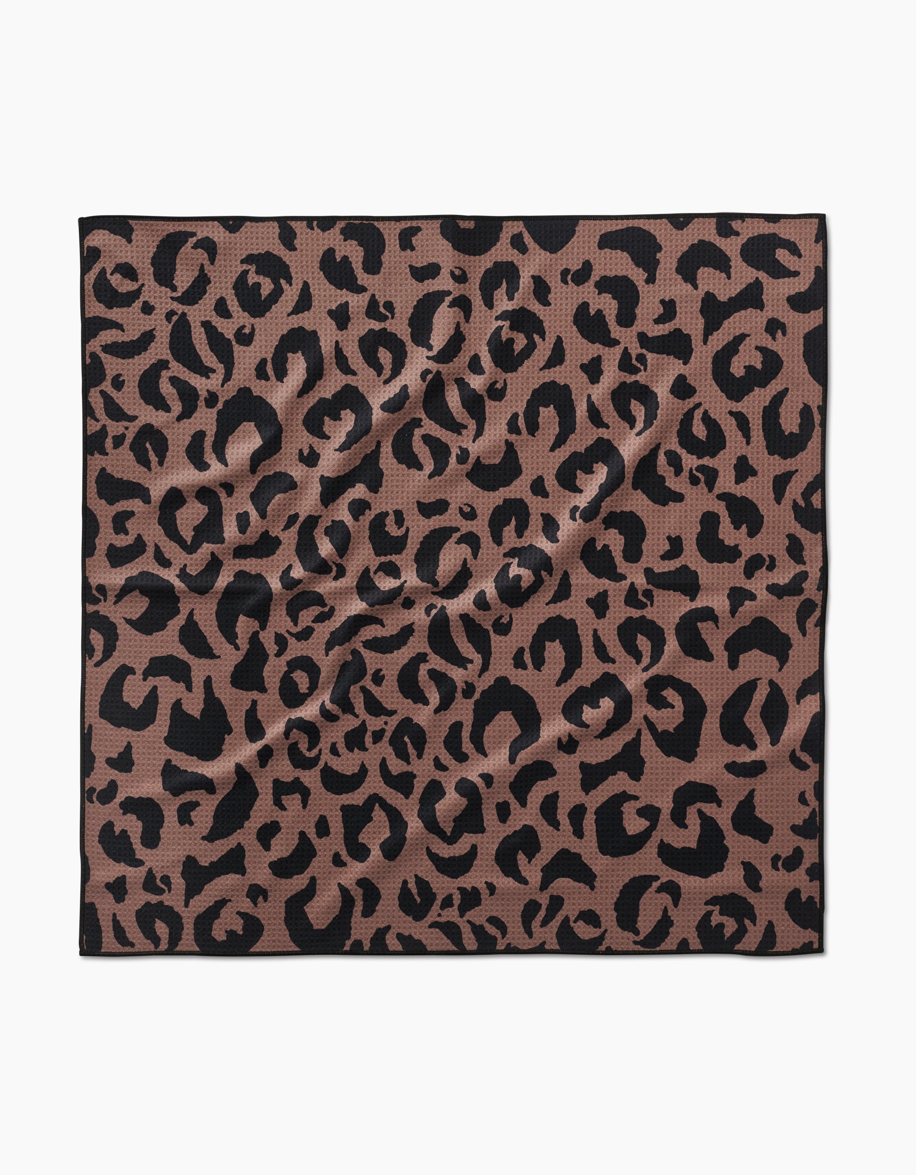 The Geometry Cheetah Hound is a square scarf made from recycled materials, featuring a brown base with an all-over black cheetah print, shown laid flat with subtle wrinkles.