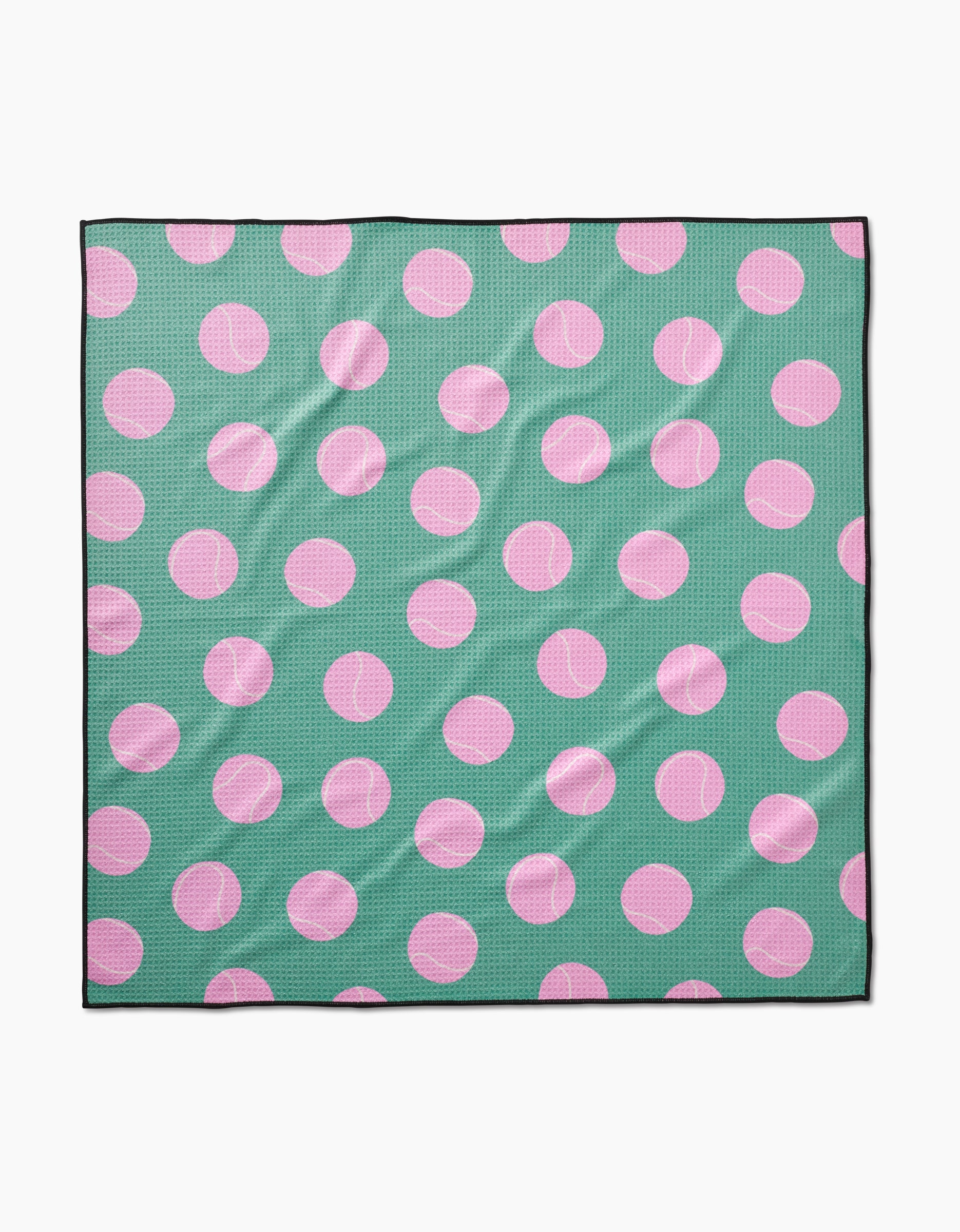 The Pink Ball dog towel by Geometry is a square, highly absorbent fabric towel made from recycled materials. It features a green background with large pink polka dots and a thin black border, and may appear slightly wrinkled.