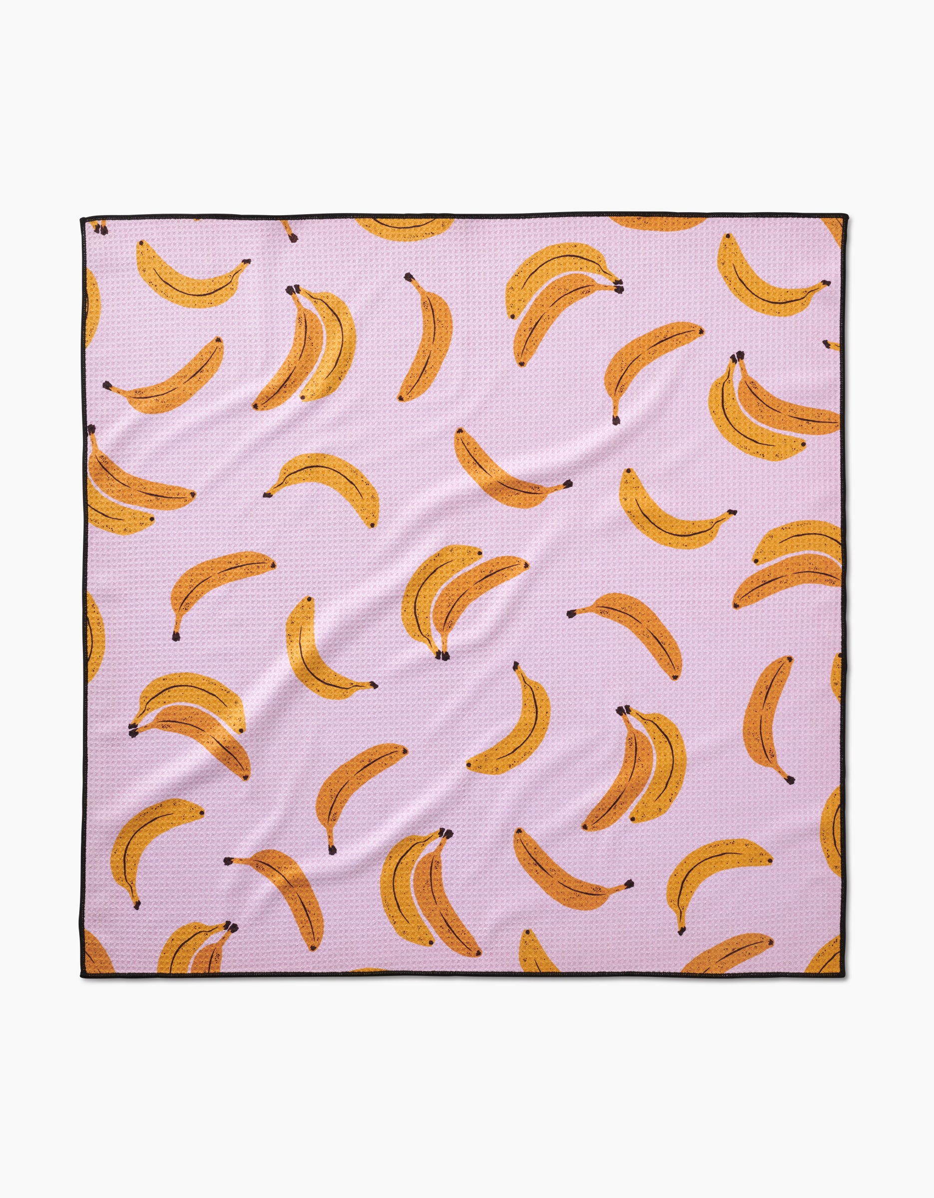 The Geometry Pupnana is a pink, square dog towel made from recycled materials, featuring a highly absorbent surface with an all-over pattern of yellow bananas—some single, some in bunches.