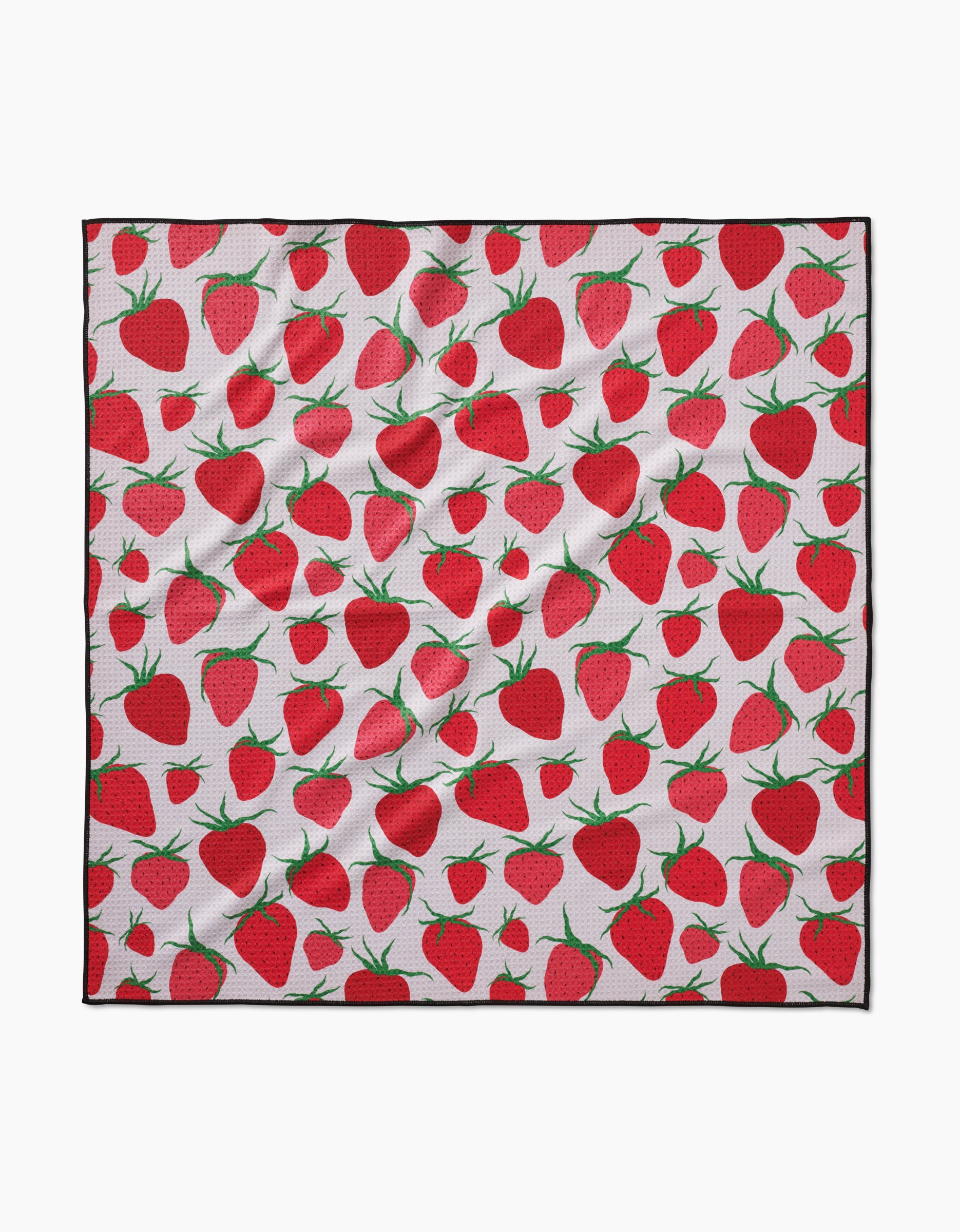 The Geometry Strawberry Sniff is a square white dog towel with a vibrant red strawberry and green leaf pattern, made from absorbent, eco-friendly fabric that appears slightly wrinkled.