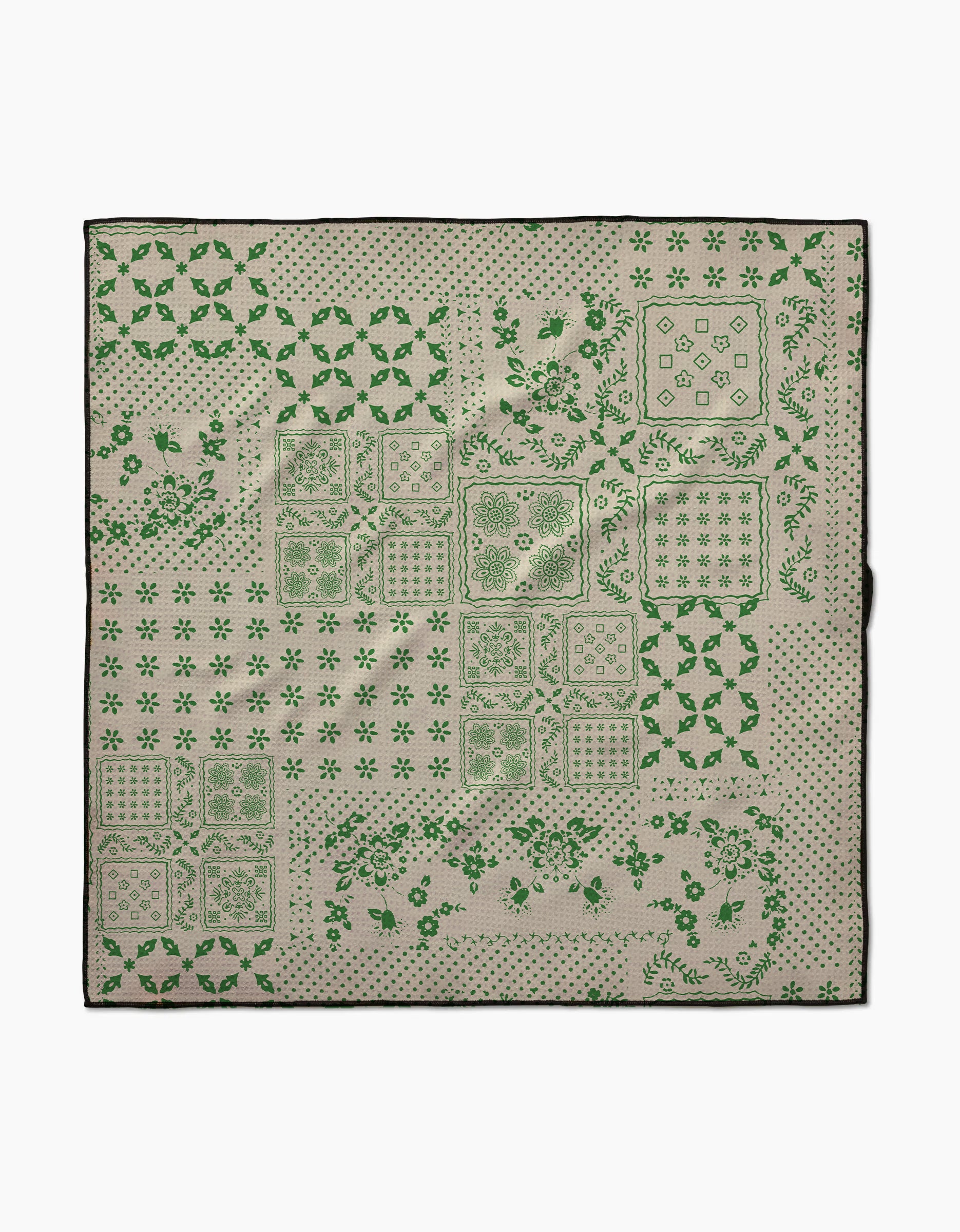 The Geometry Blossoming Bandanna Green is a square fabric dog towel with green geometric and floral patterns on beige, bordered in black. Highly absorbent and crafted from recycled materials.