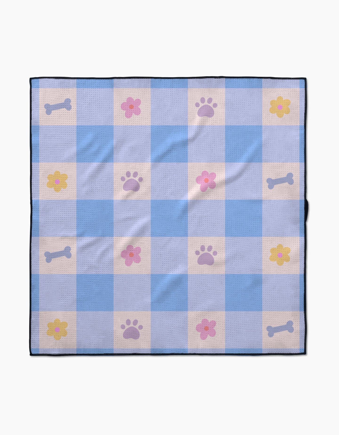 The Blue Sky Picnic Dreams dog towel by Letters By Shells features blue and white checks with pink flowers, purple paw prints, and light gray dog bones. Made from recycled materials, it’s finished with a dark blue border.