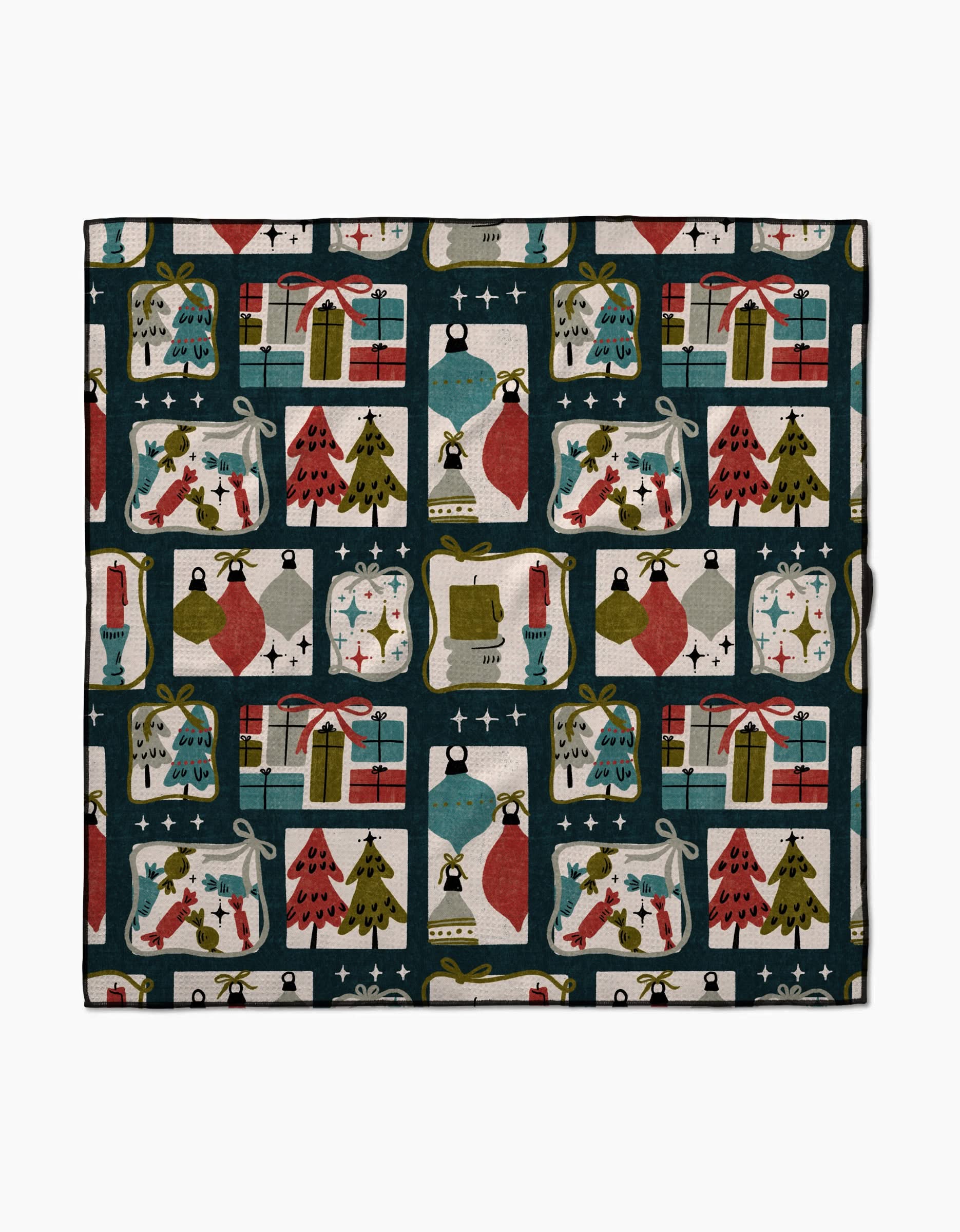 Amy MacCreadys Cady Dark is a square cloth made from recycled materials, featuring a festive holiday pattern with presents, trees, ornaments, stockings, candles, and stars in red, green, blue, and gold on a cream background.