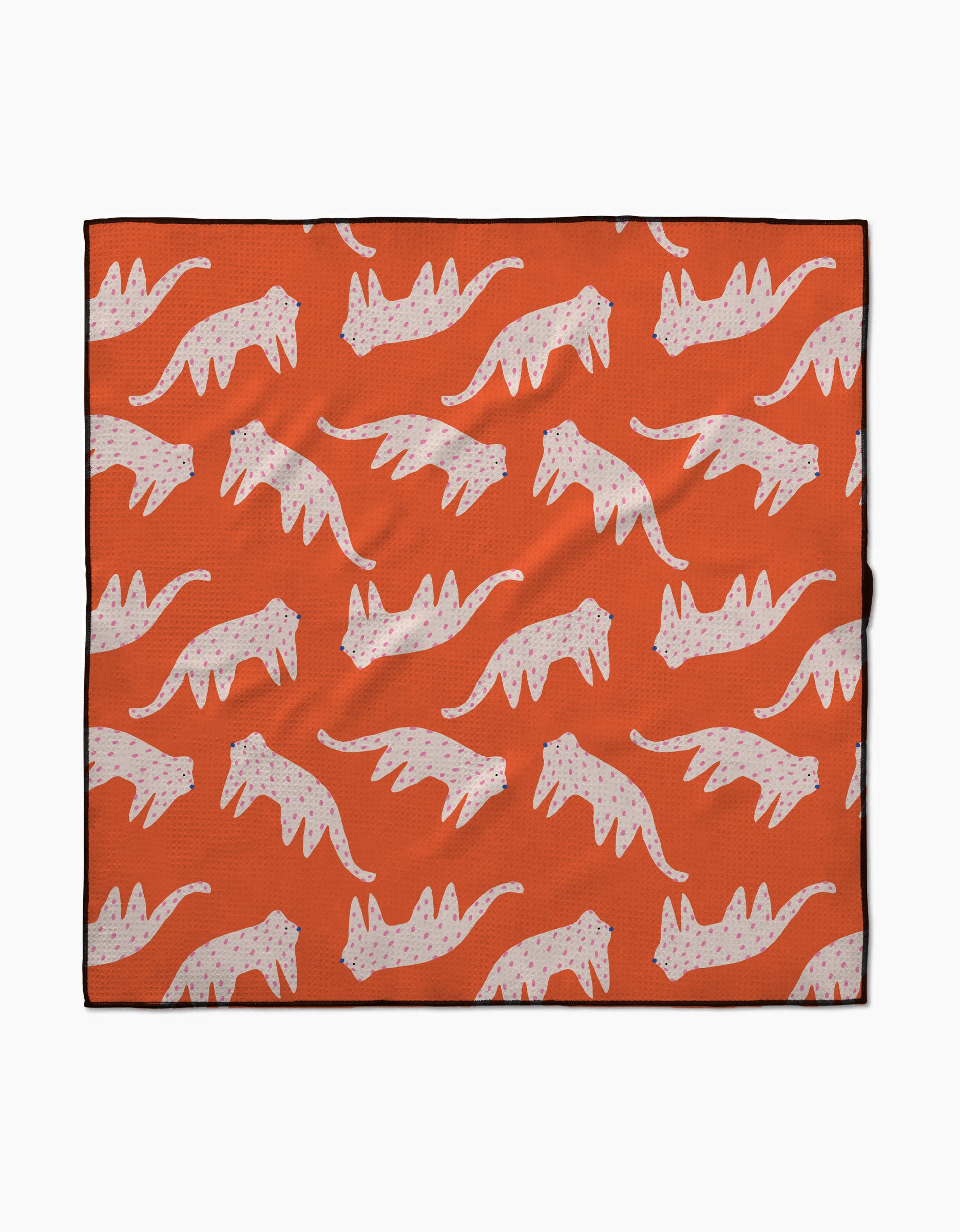 The Cute Cheetah blanket by Jennifer Bouron is lightweight and eco-friendly, featuring a repeating pattern of white cats with pink spots in a walking pose on an orange background.