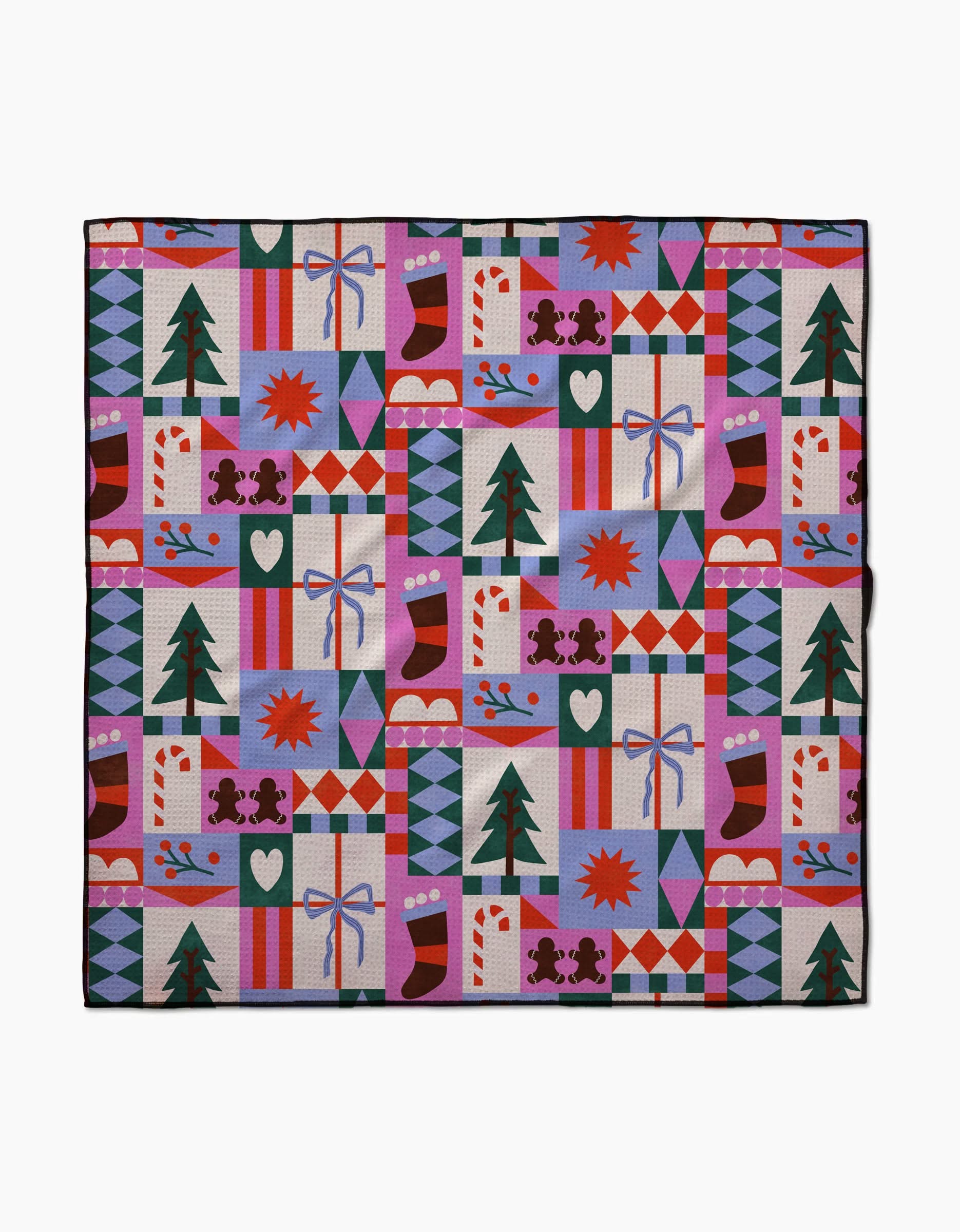 The Claire Iglesias Festive Christmas Quilt features a grid of red, green, purple, blue, and white with trees, stockings, gifts, bows, candy canes, hearts, stars, and geometric shapes on recycled fabric.