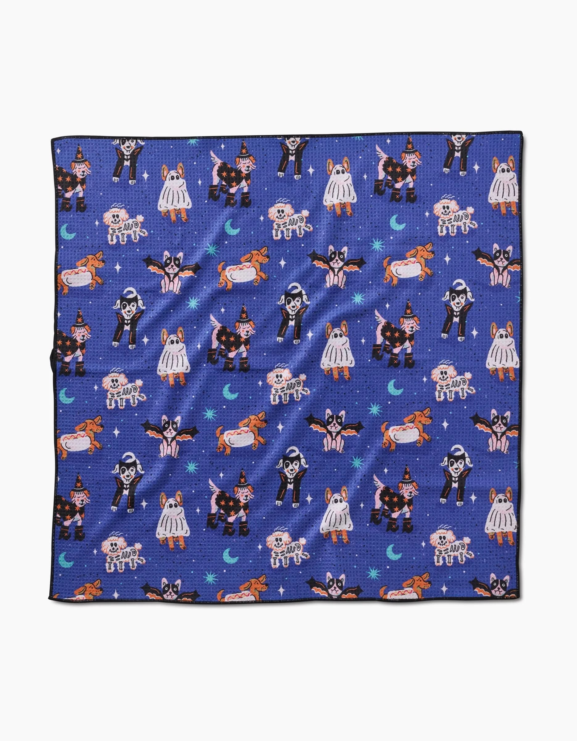 The Halloween Hounds blue handkerchief by Camila Leão is made from recycled materials and features Halloween cats dressed as witches, skeletons, ghosts, and more amid stars, moons, and pumpkins.