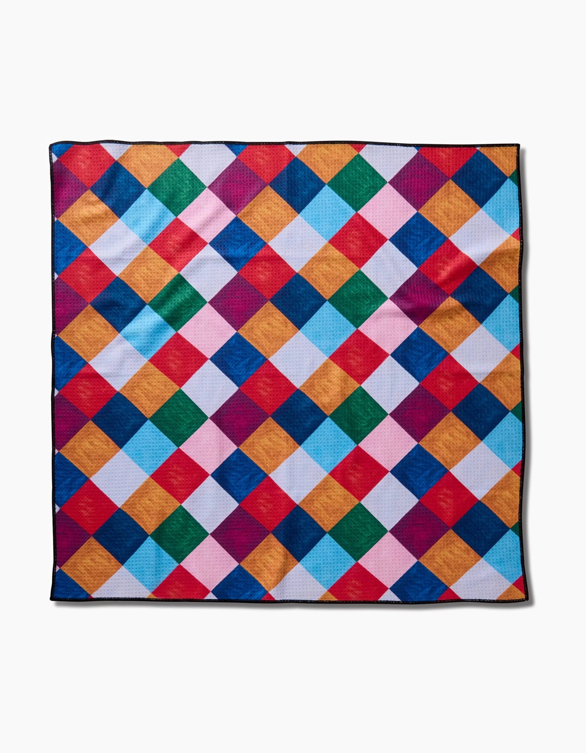 The Holiday Harlequin quilt by Daria Solak features a vibrant diamond pattern in red, blue, green, yellow, pink, and orange on white. Its a square quilt crafted from recycled materials.