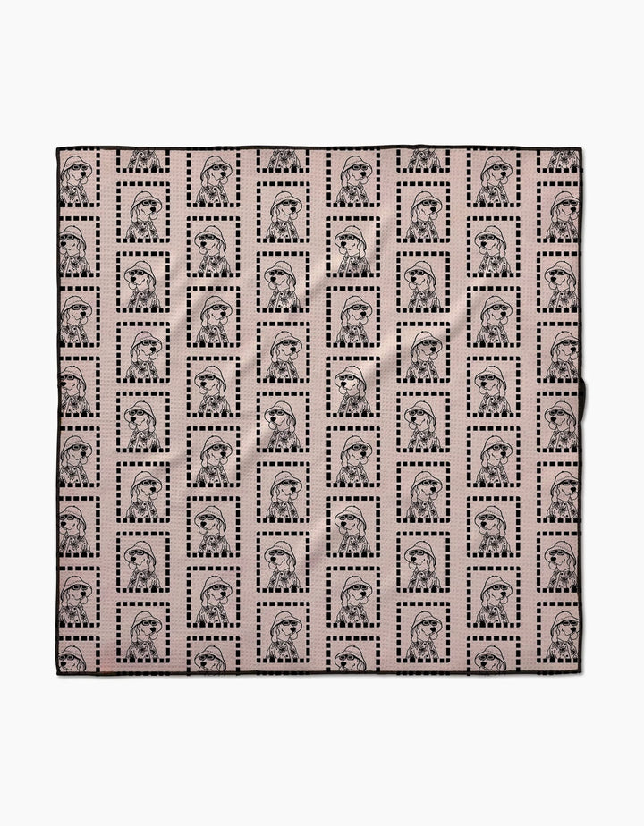 The Geometry Ready For Summer Doggy is an eco-friendly, absorbent fabric square with repeated womens faces in dotted rectangles on a light pink background—perfect as stylish dog towels.