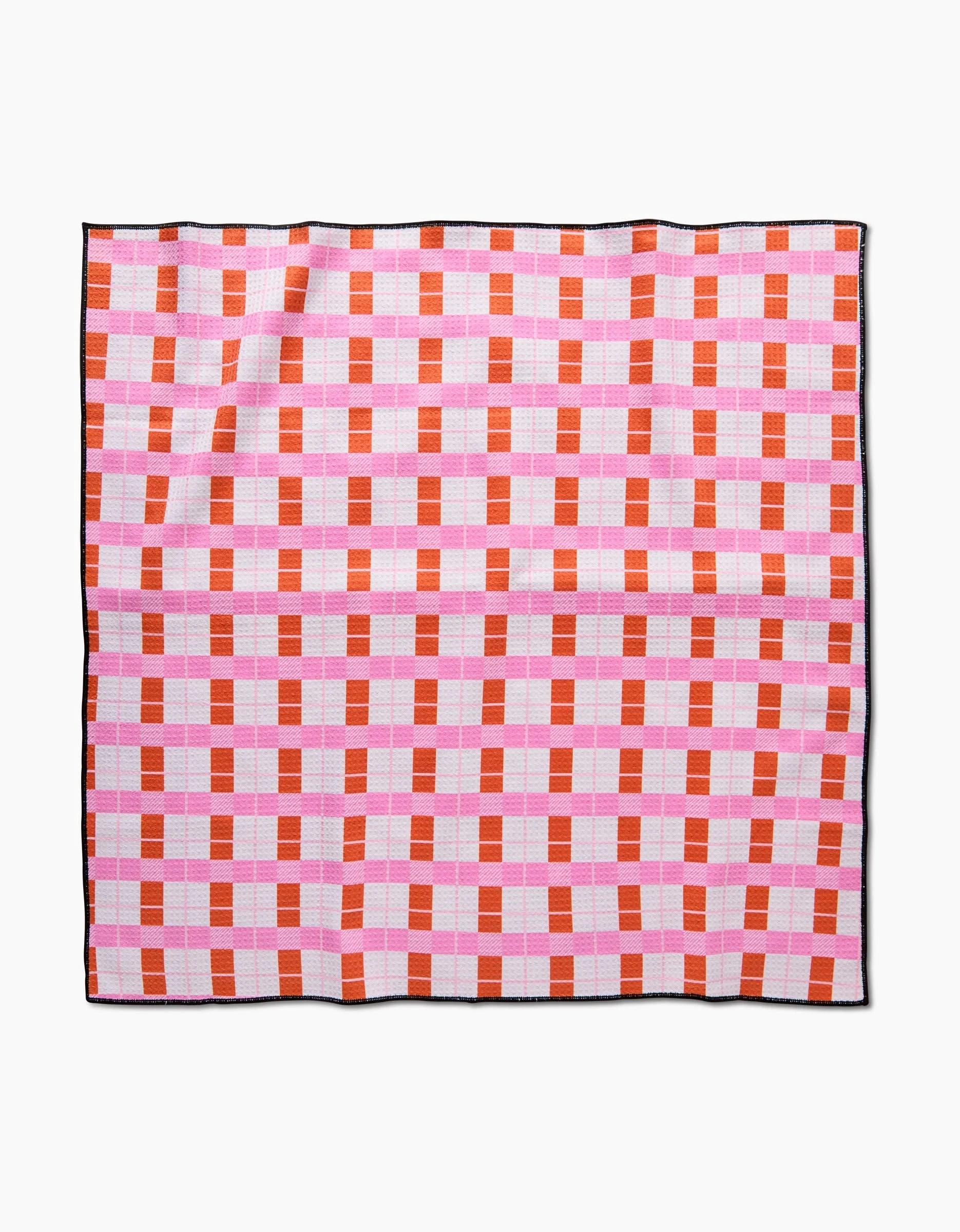 The Megan Roy Red Pink Plaid is a square dog towel with a red and pink checkered pattern, small white squares, a thin black border, and is made from highly absorbent recycled materials. It is shown laid flat on a white background.