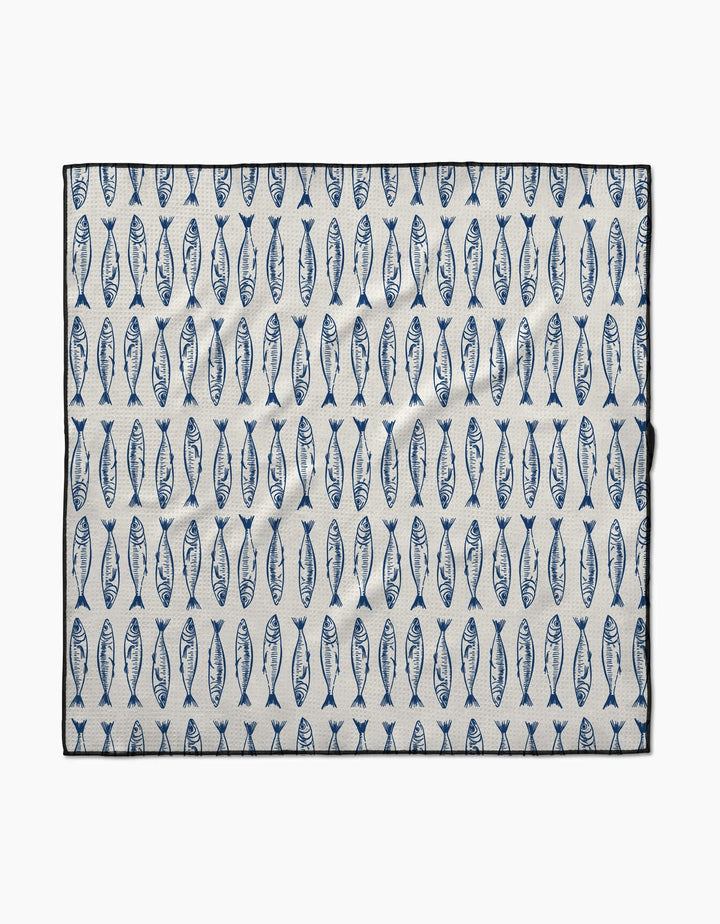 The Sardine Stripes mat by Hufton Studio is a rectangular white mat made from recycled materials, featuring rows of evenly spaced vertical blue fish and a black border.