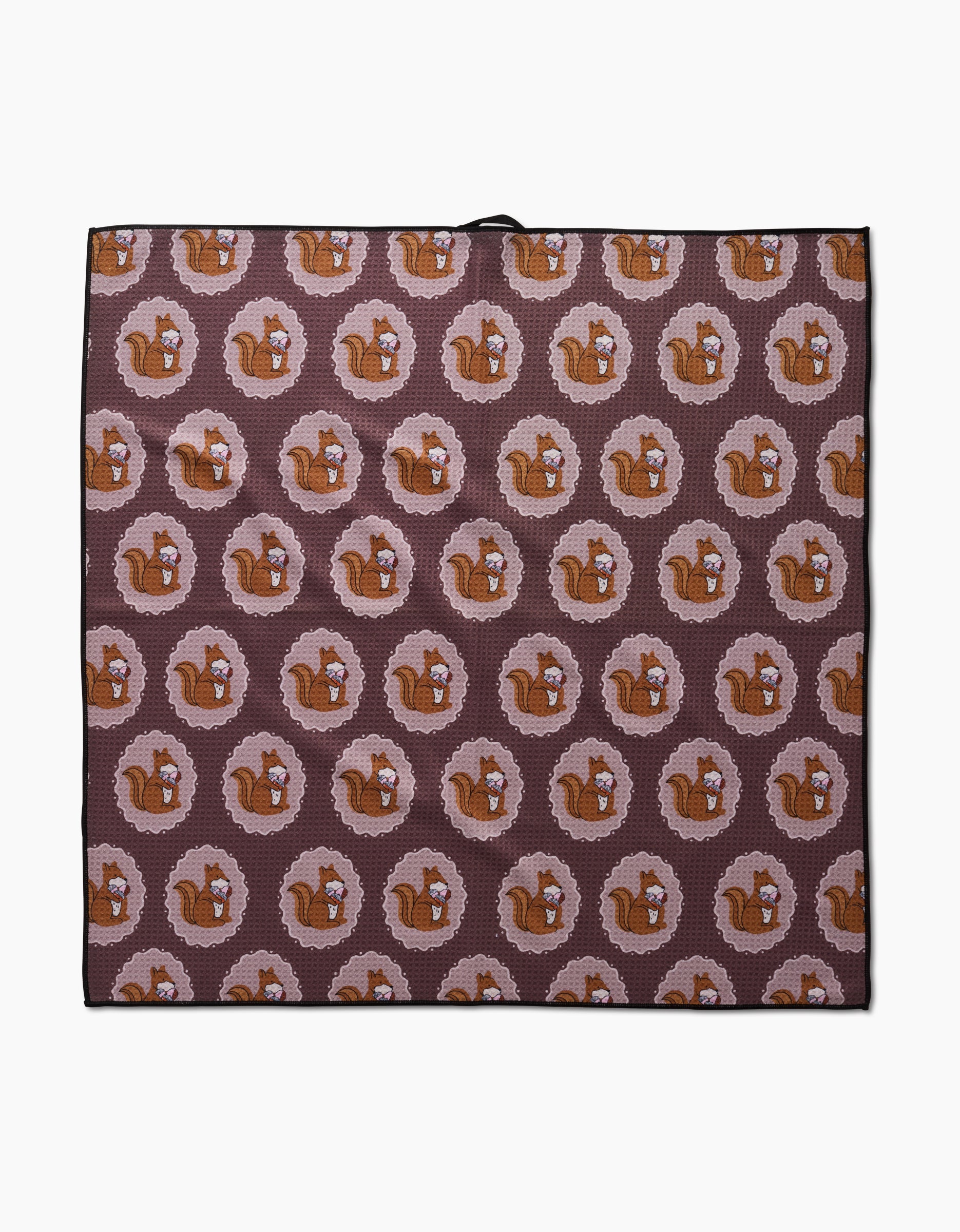 The Megan Roy Squirrels Brown mat is an eco-friendly, rectangular dog towel with a repeating pattern of brown squirrels in pink rings on a dark background. Highly absorbent and perfect for your furry friend.