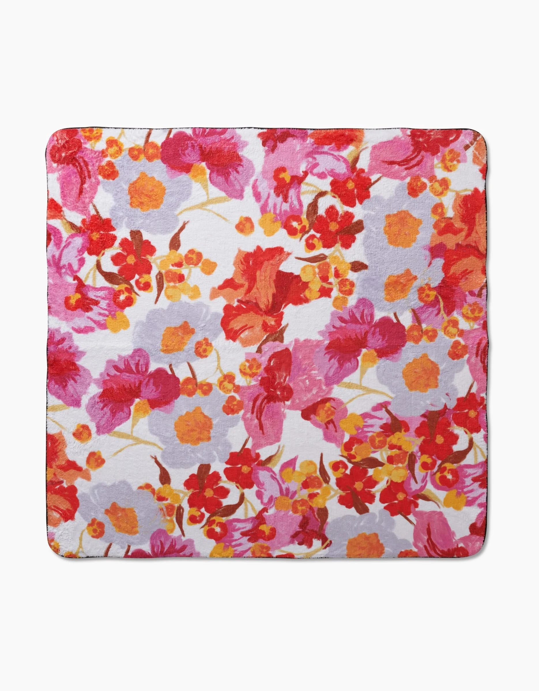 The Geometry Pup Florals is a square cloth crafted from recycled materials, featuring a densely arranged, vibrant floral pattern in red, orange, yellow, and pink on white for a lively look.