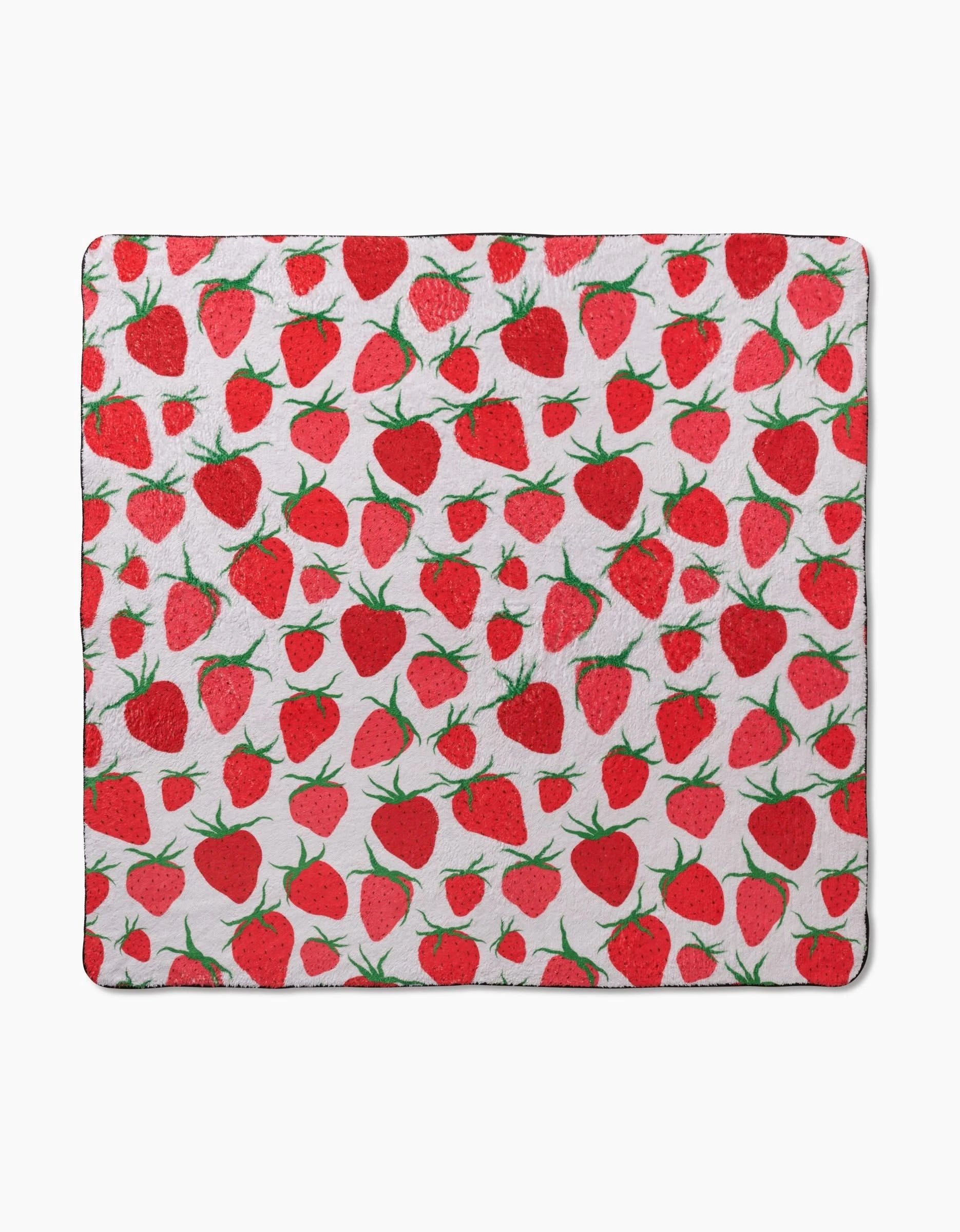The Geometry Strawberry Sniff is a square blanket with a white background and a repeating red strawberry and green leaf pattern, made from recycled materials for eco-friendly comfort.