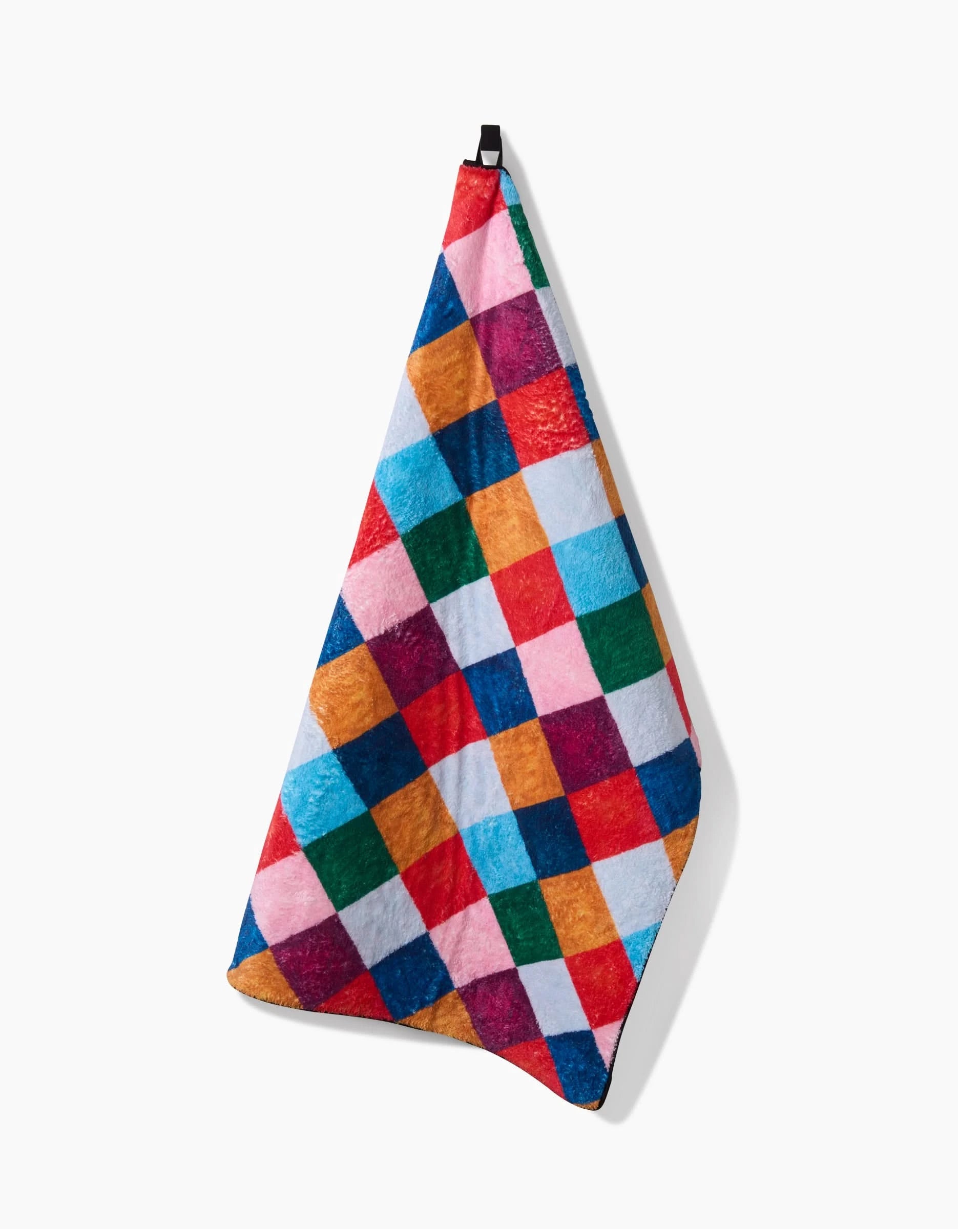 The Daria Solak Holiday Harlequin is a hanging ultra-absorbent dog towel with a vibrant checkered pattern featuring red, blue, green, yellow, and pink squares on white.