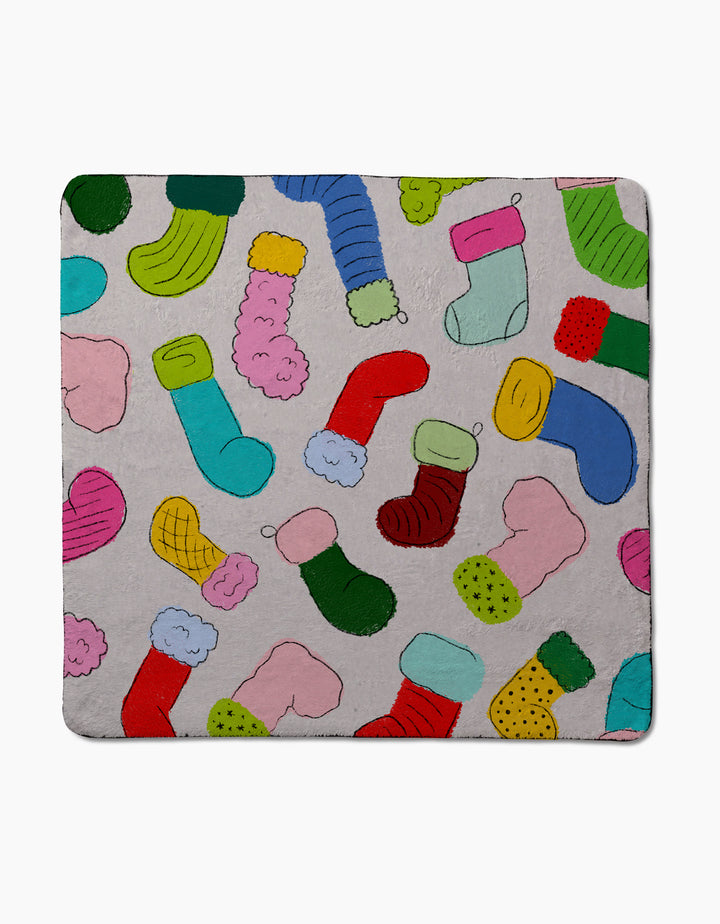 The Geometry Silly Stockings blanket features a playful pattern of colorful Christmas stockings on light gray and is made from ultra-absorbent dog towel material for cozy comfort.