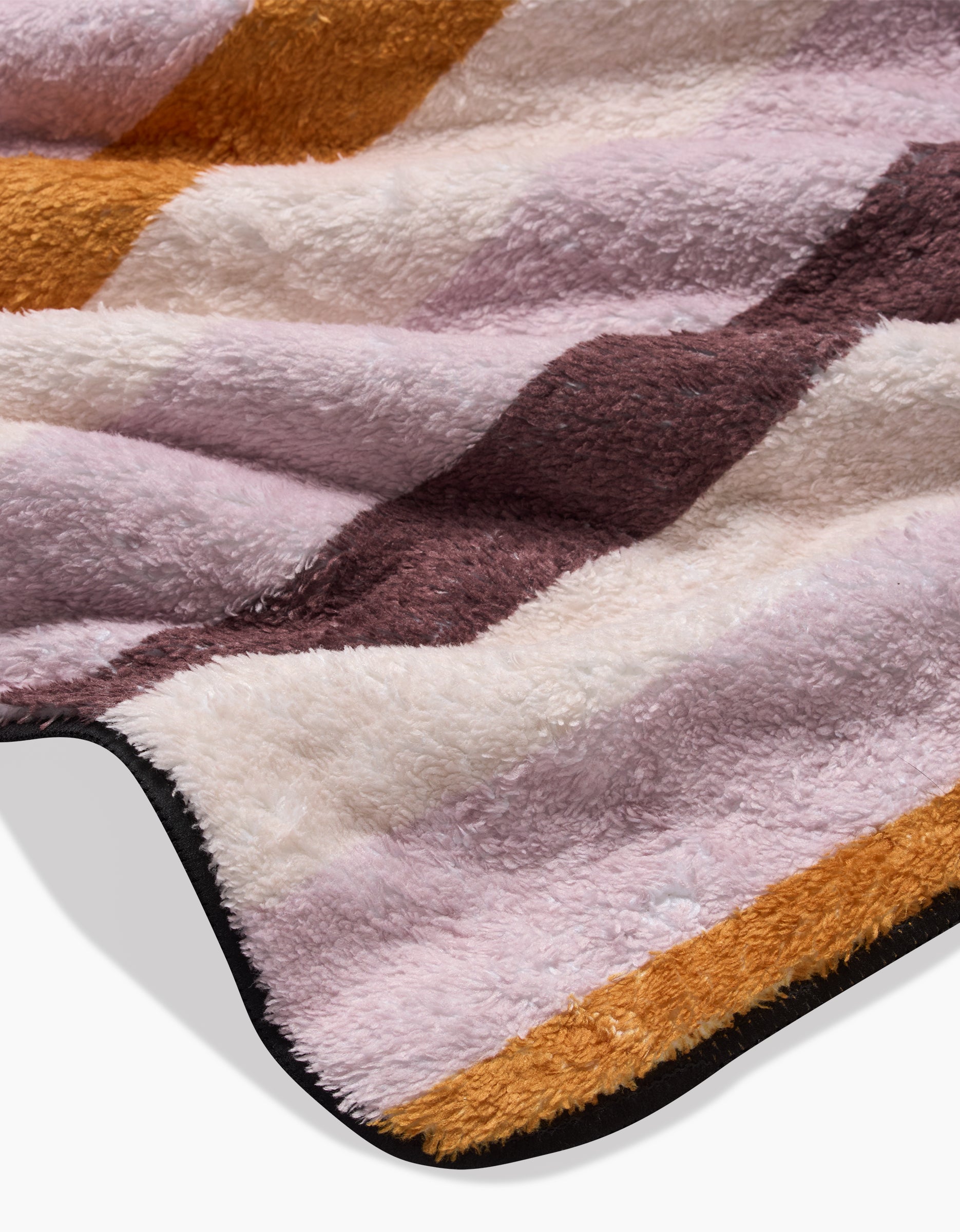 A close-up of Megan Roys Squirrels Stripe dog towel shows its ultra-absorbent, soft, fluffy texture with wide pastel pink, brown, and mustard yellow stripes, finished with a black border.