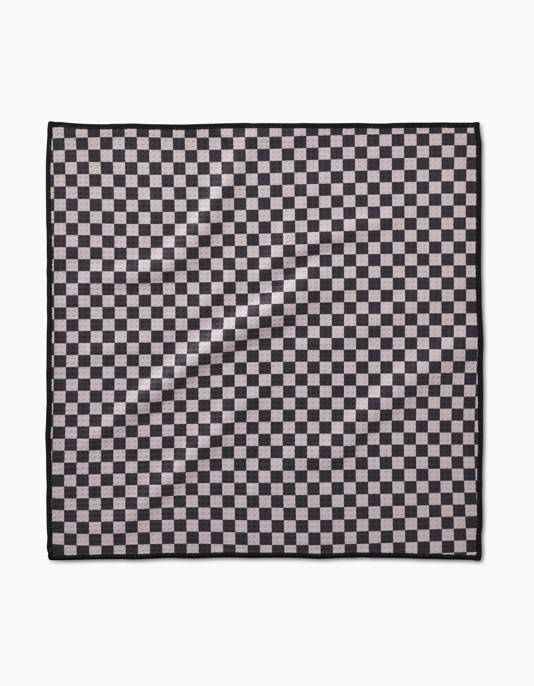 The Geometry Cool Pup Paw Towel features a black and grey checkerboard pattern with a thin black border. Made from ultra-absorbent Geoweave fabric, it’s shown on a white background.