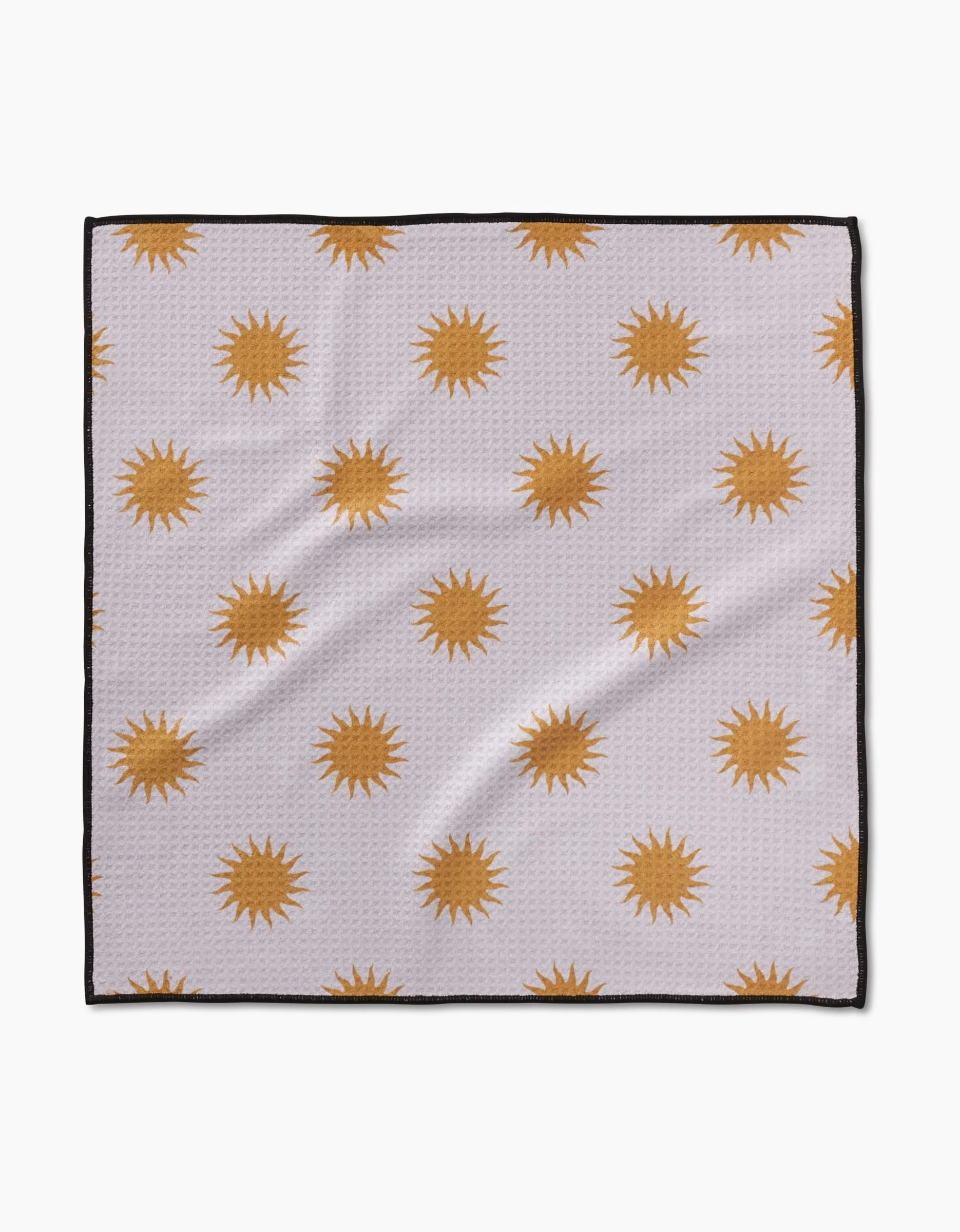 The Geometry Feeling Sunny cloth is made from ultra-absorbent Geoweave fabric. It features golden yellow sunbursts on a white background with black-outlined edges for a modern look.