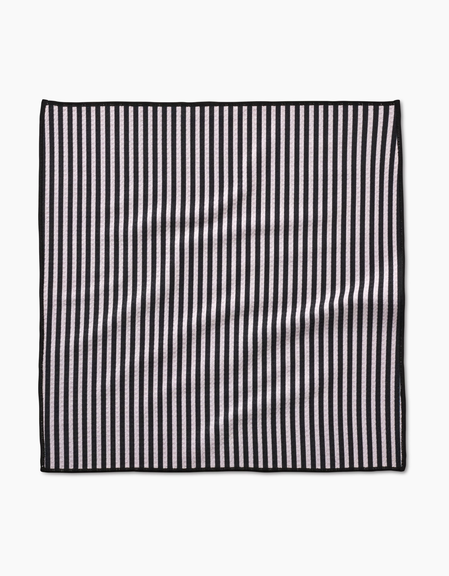 The Geometry Good Pup rectangular Paw Towel features vertical black and white stripes, a thin black border, and is made from ultra-absorbent recycled materials, shown on a plain white background.