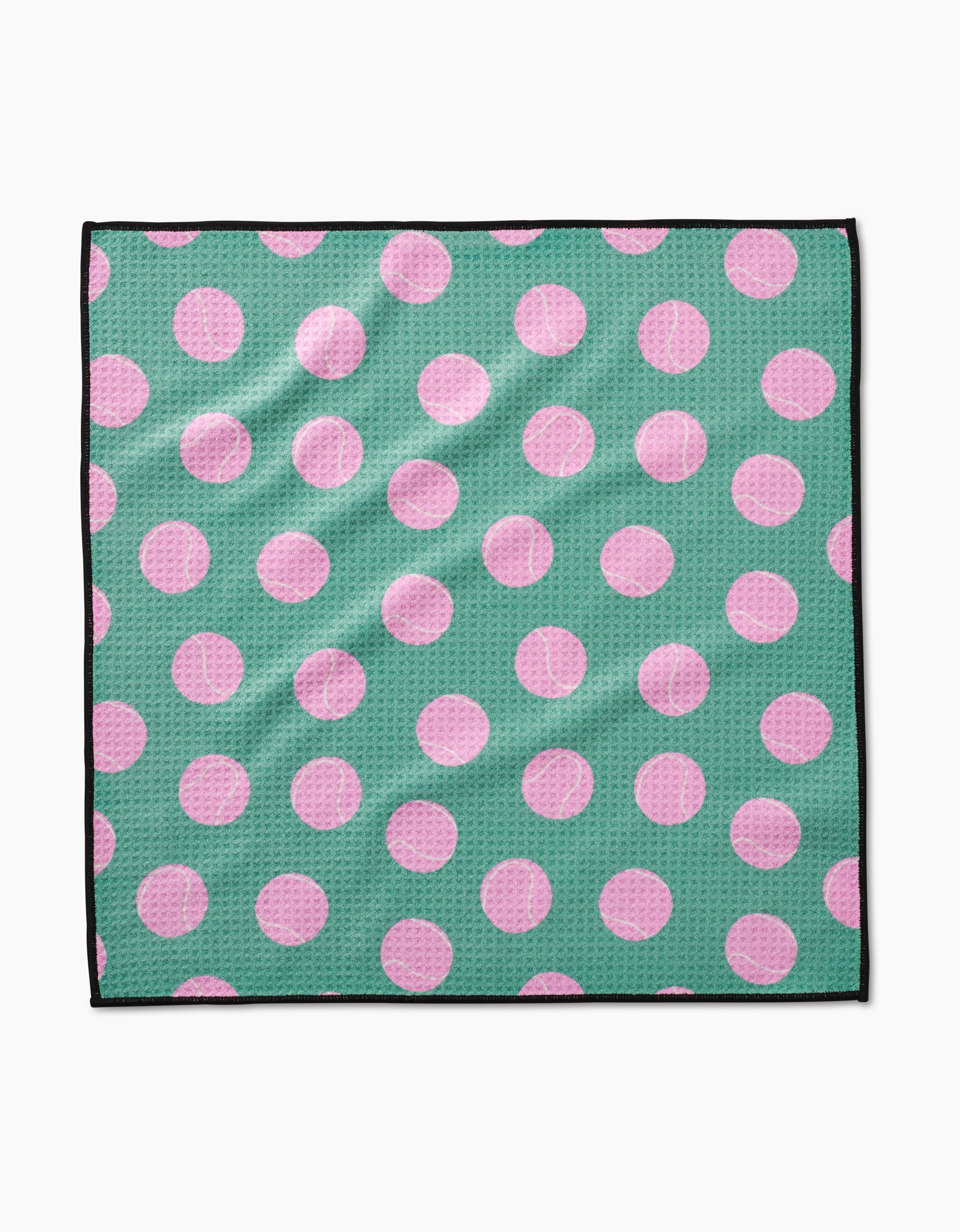 The Geometry Pink Ball is a square cloth made from ultra-absorbent Geoweave fabric, featuring large pink polka dots on a green background and a thin black edge.