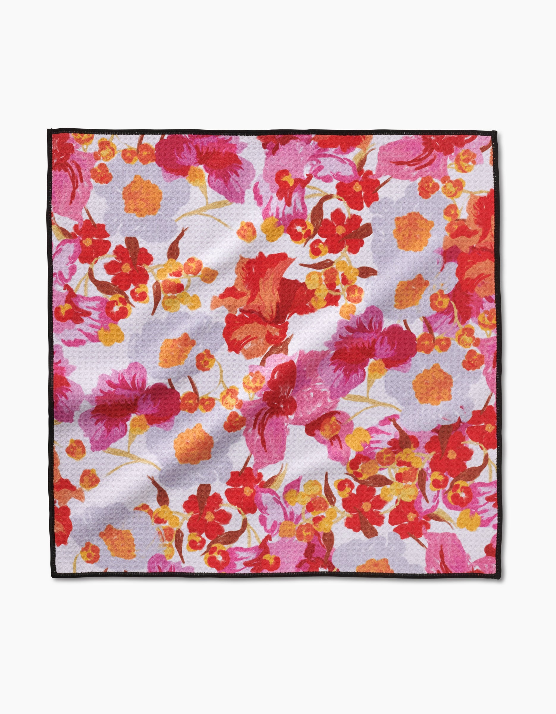 The Geometry Pup Florals Paw Towel features a vibrant floral pattern in red, pink, orange, and yellow on a light background, finished with a black border and made from ultra-absorbent Geoweave fabric.