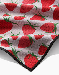 The Geometry Strawberry Sniff Paw Towel is a soft, light-gray towel made from ultra-absorbent Geoweave fabric, featuring a repeating red strawberry and green leaf pattern with a black-edged border.