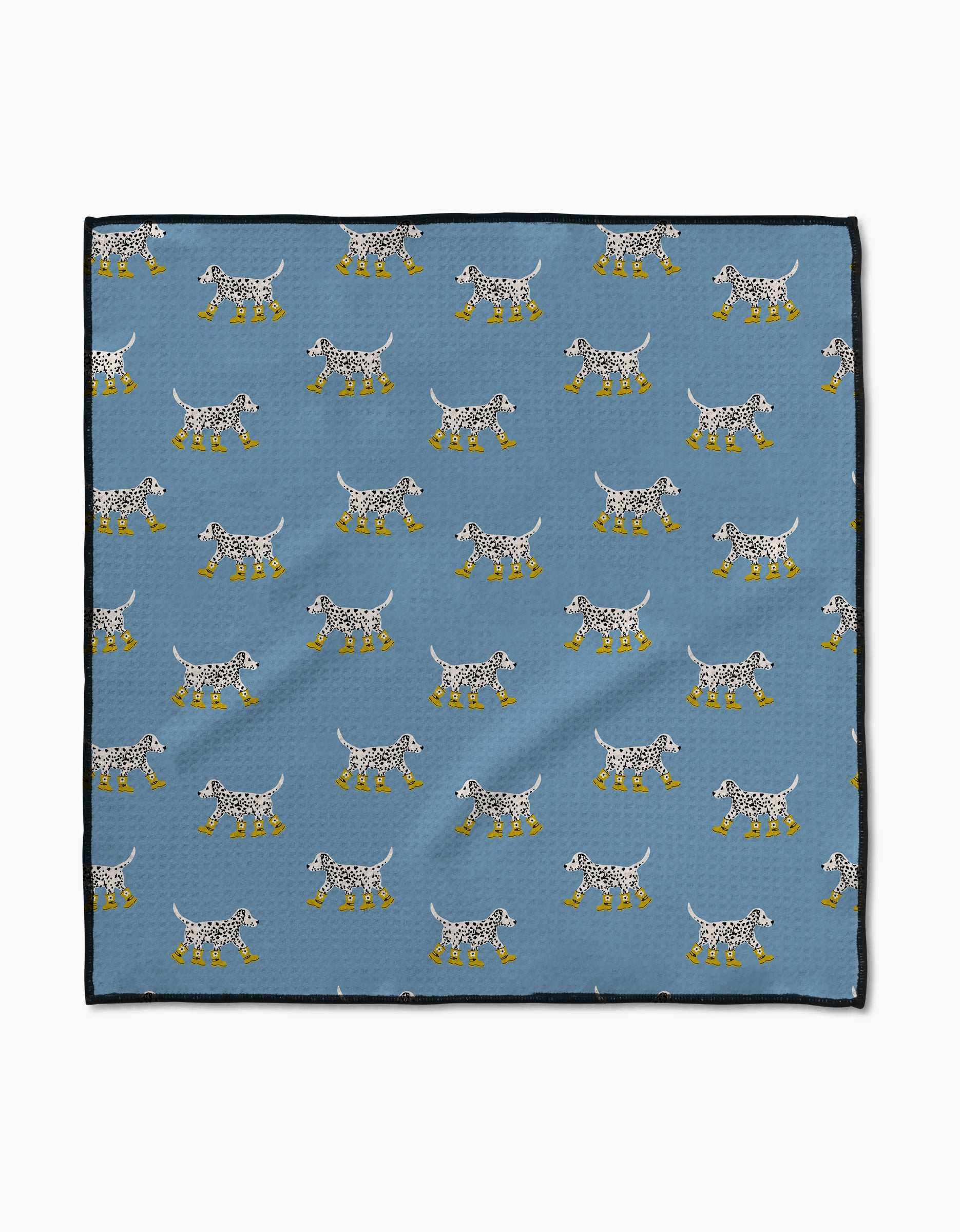 The Geometry Dalmatian In Boots Blue Paw Towel features a blue Geoweave cloth with white spotted dogs in yellow boots, arranged in rows facing both ways, and finished with black borders for a stylish touch.