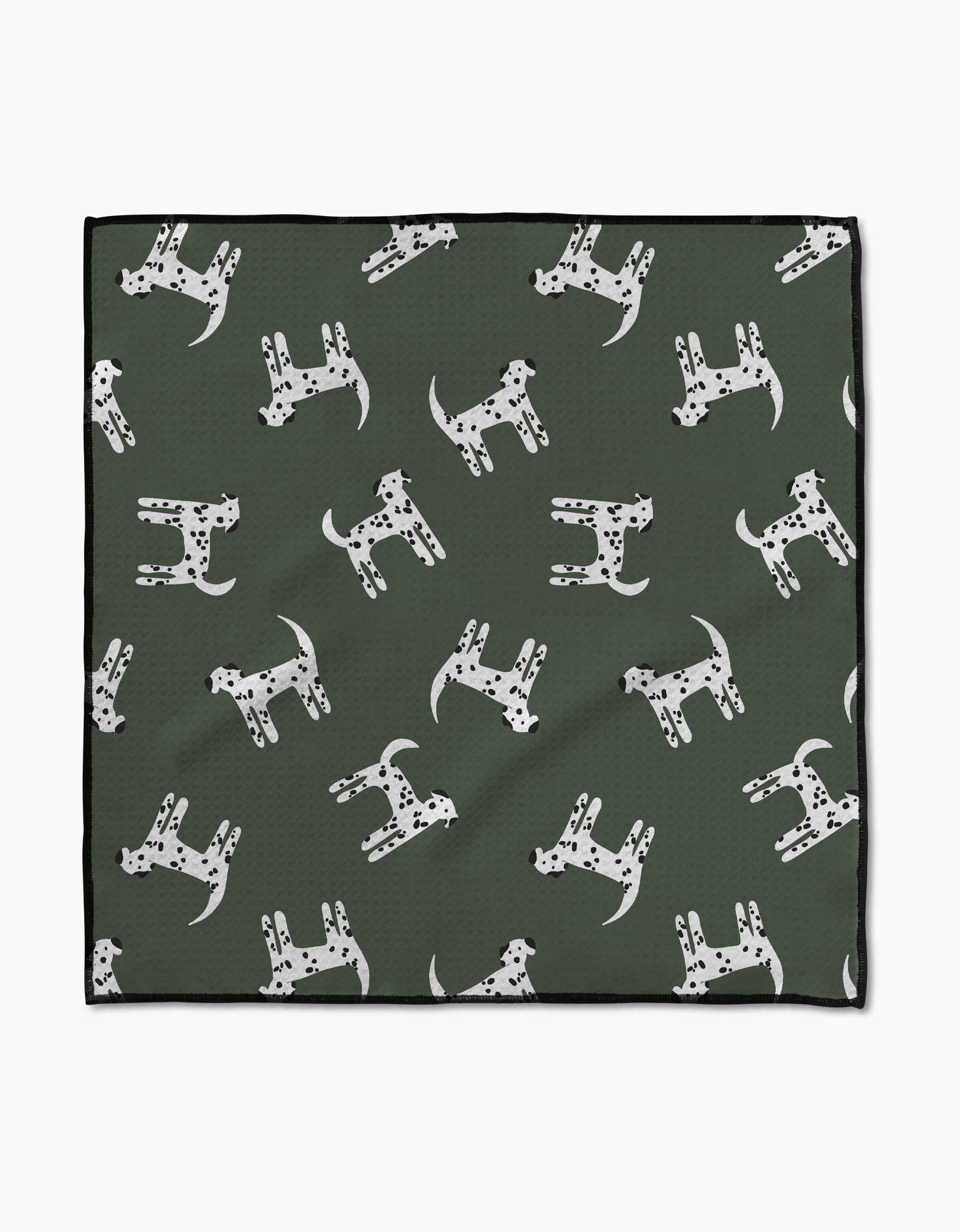 The Coit Creative “Dalmation Dogs” Paw Towel features a green Geoweave fabric with white Dalmatian dog patterns, each with unique black spots, and a chic black border for style and absorbency.