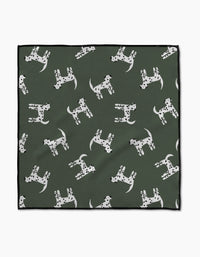 The Coit Creative “Dalmation Dogs” Paw Towel features a green Geoweave fabric with white Dalmatian dog patterns, each with unique black spots, and a chic black border for style and absorbency.