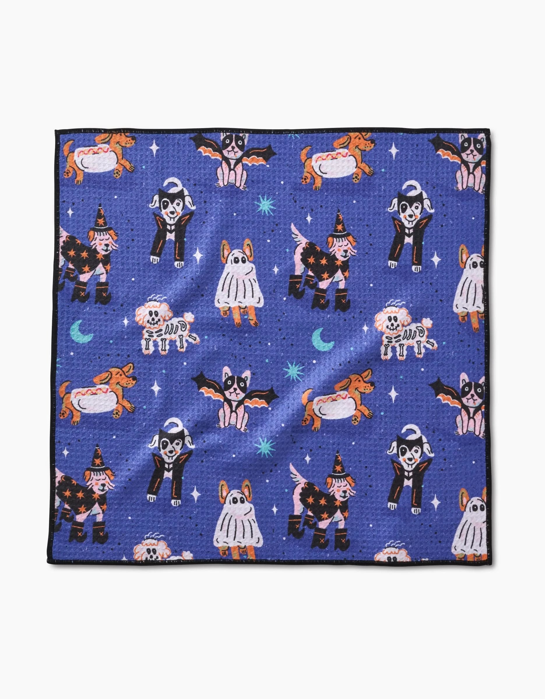 The Halloween Hounds dog towel by Camila Leão features cartoon dogs in Halloween costumes among stars and moons. Ultra-absorbent, it combines festive design with everyday practicality.