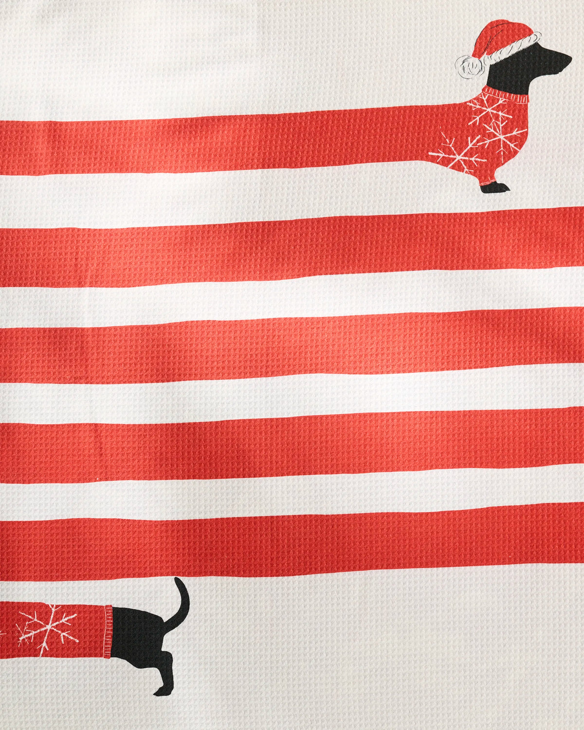 Bring holiday cheer to your space with Geometry’s Holiday Stretch towel, featuring a festive cartoon dachshund in a Santa hat and red sweater stretching across bold red and white stripes—perfect as a recycled dog towel or ultra-absorbent pet towel.
