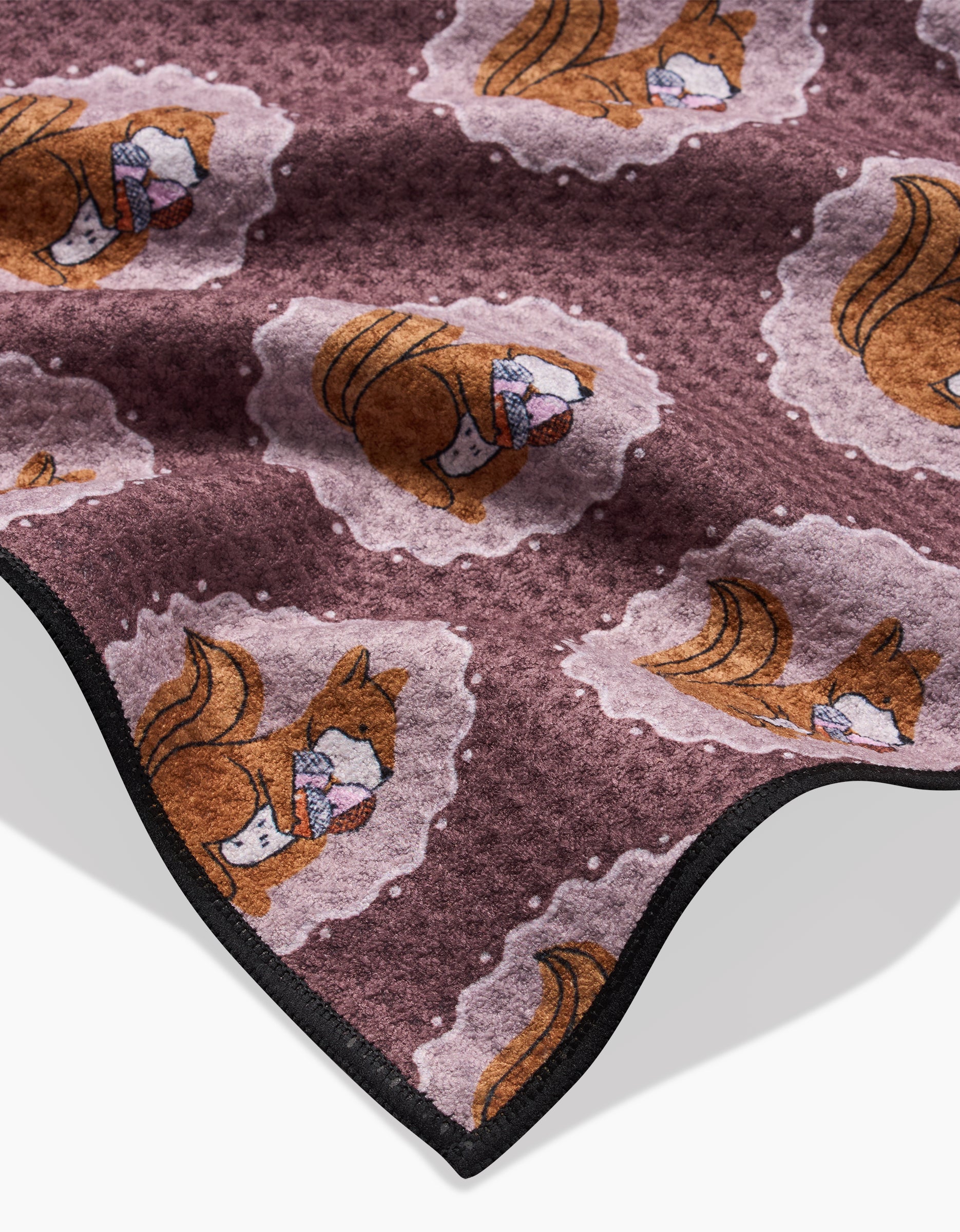 The Megan Roy Squirrels Brown blanket is crafted from ultra-absorbent Geoweave fabric and features playful cartoon squirrels on a brown background with black trim.
