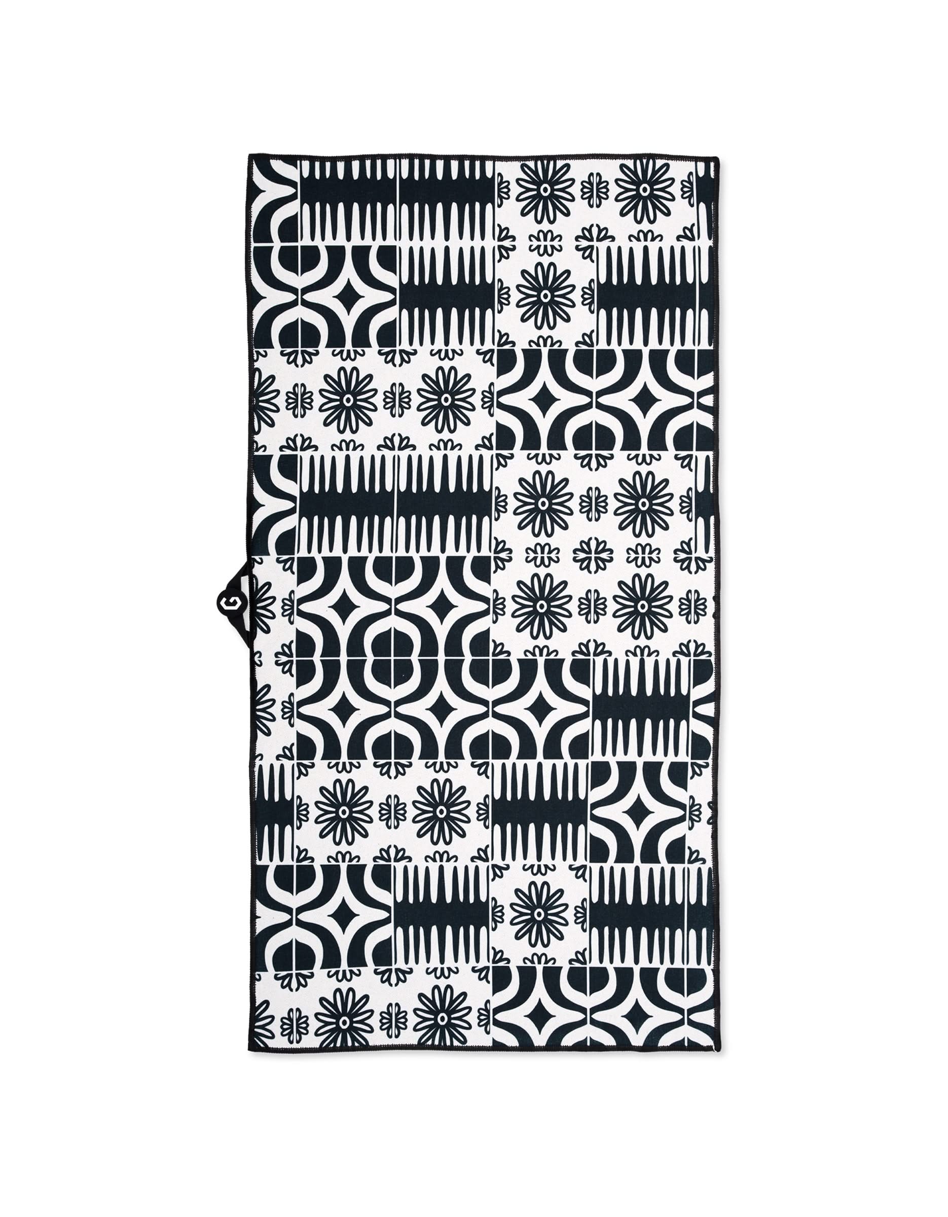 The GEOMETRY Magna - Bohemian Mosaic gym towel is rectangular and ultra-absorbent, featuring a black and white geometric and floral patchwork with circles, lines, and flower-like shapes.