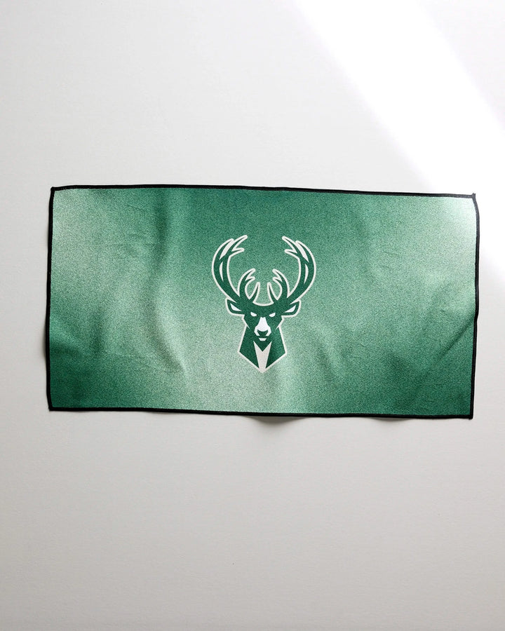 The NBALAB x Geometry Bucks Fade is a green sustainable workout towel featuring a stylized white deer head logo outlined in black, shown on a plain white background.