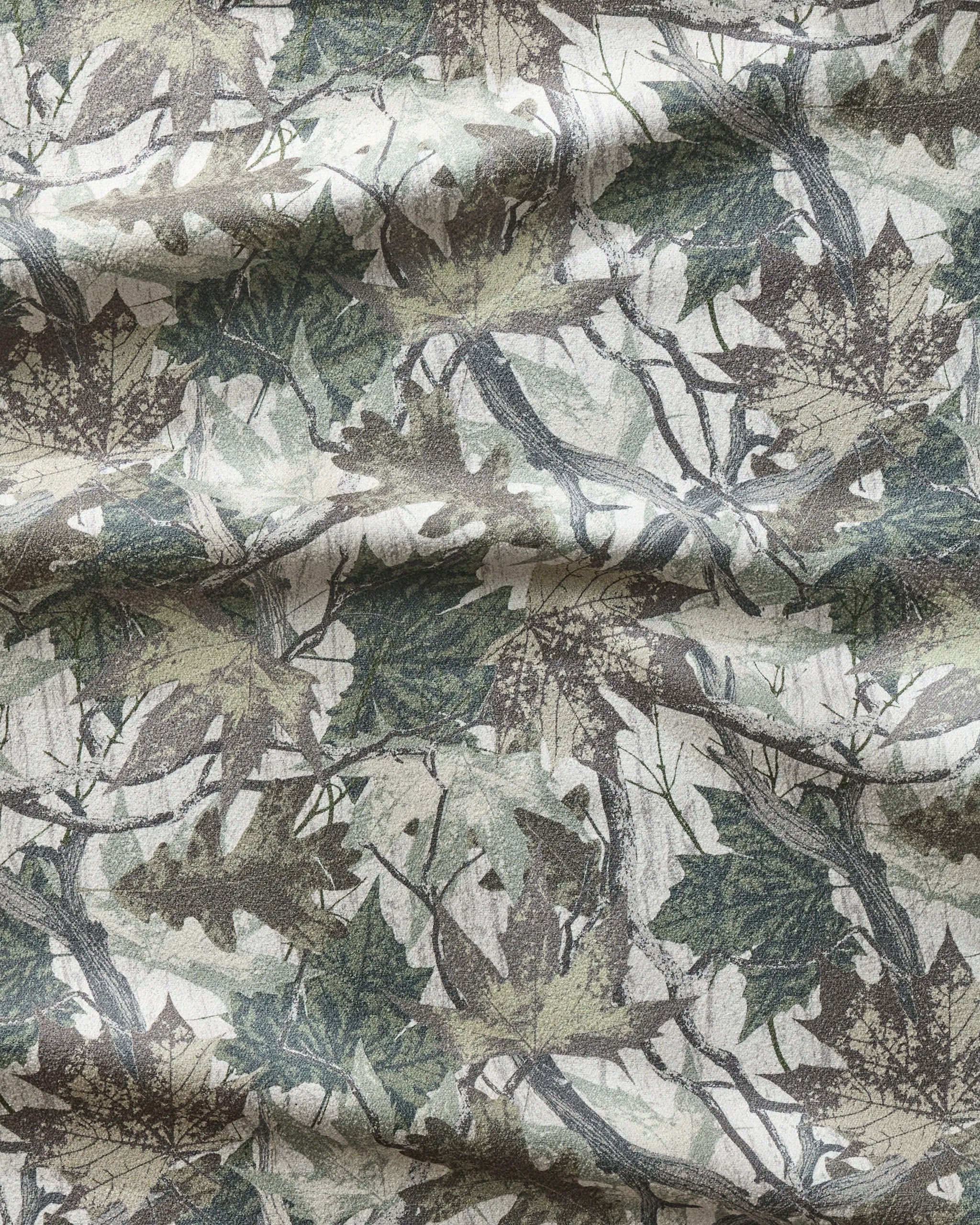 A close-up of the ultra-absorbent Dad Camo fitness towel by Geometry shows a woodland camouflage pattern in green, brown, and gray. Its visible folds highlight how fast-drying and perfect it is for workouts.