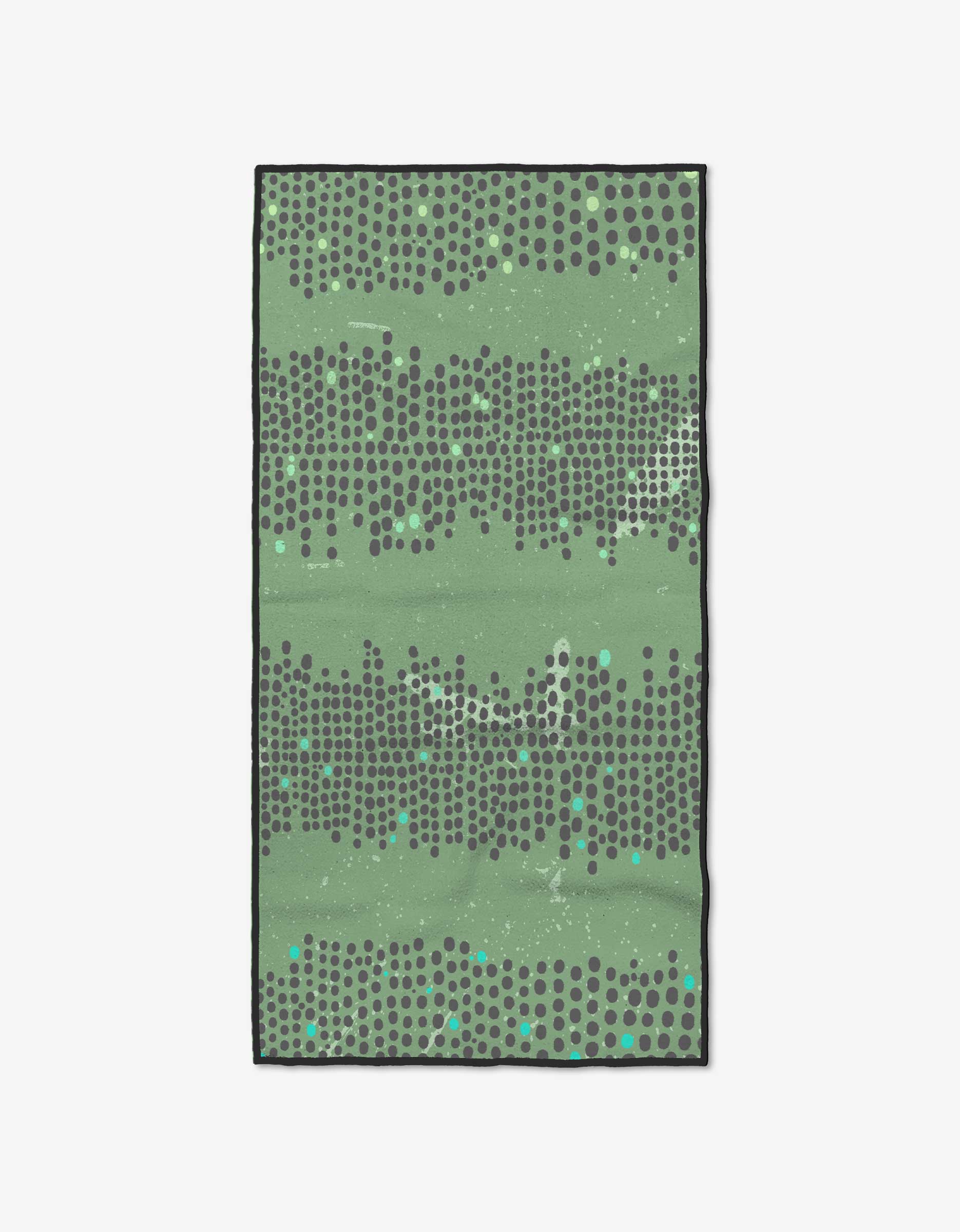 The Dash Fitness Towel by GEOMETRY is a rectangular green towel with staggered dark grey dots, lighter green and turquoise splatters, a thin black border, and is made from recycled materials.